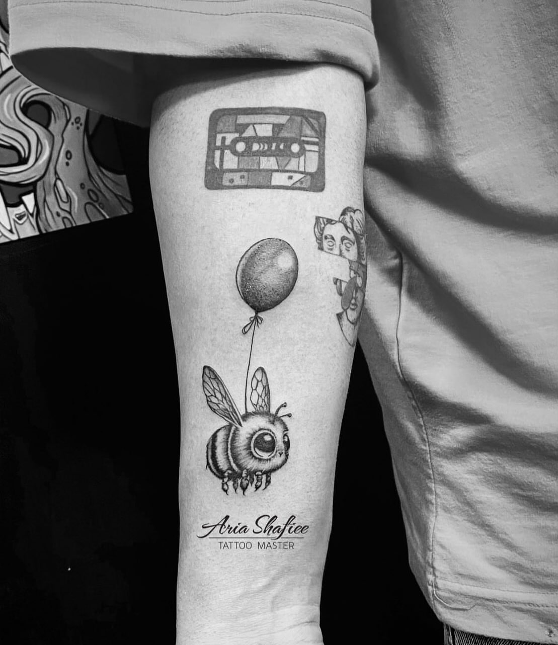 Bee with balloon geometric tattoo on the forearm by Aria Shafiee