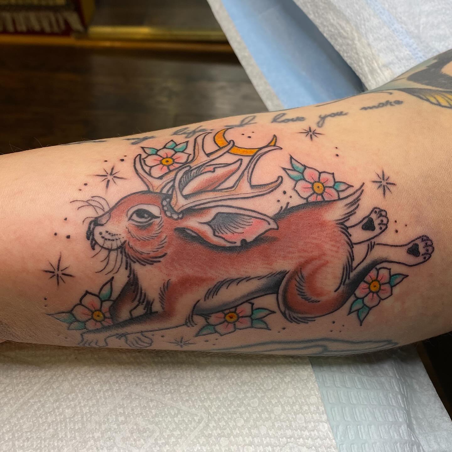 Rabbit with flowers American traditional tattoo on the forearm by Thomas Cook