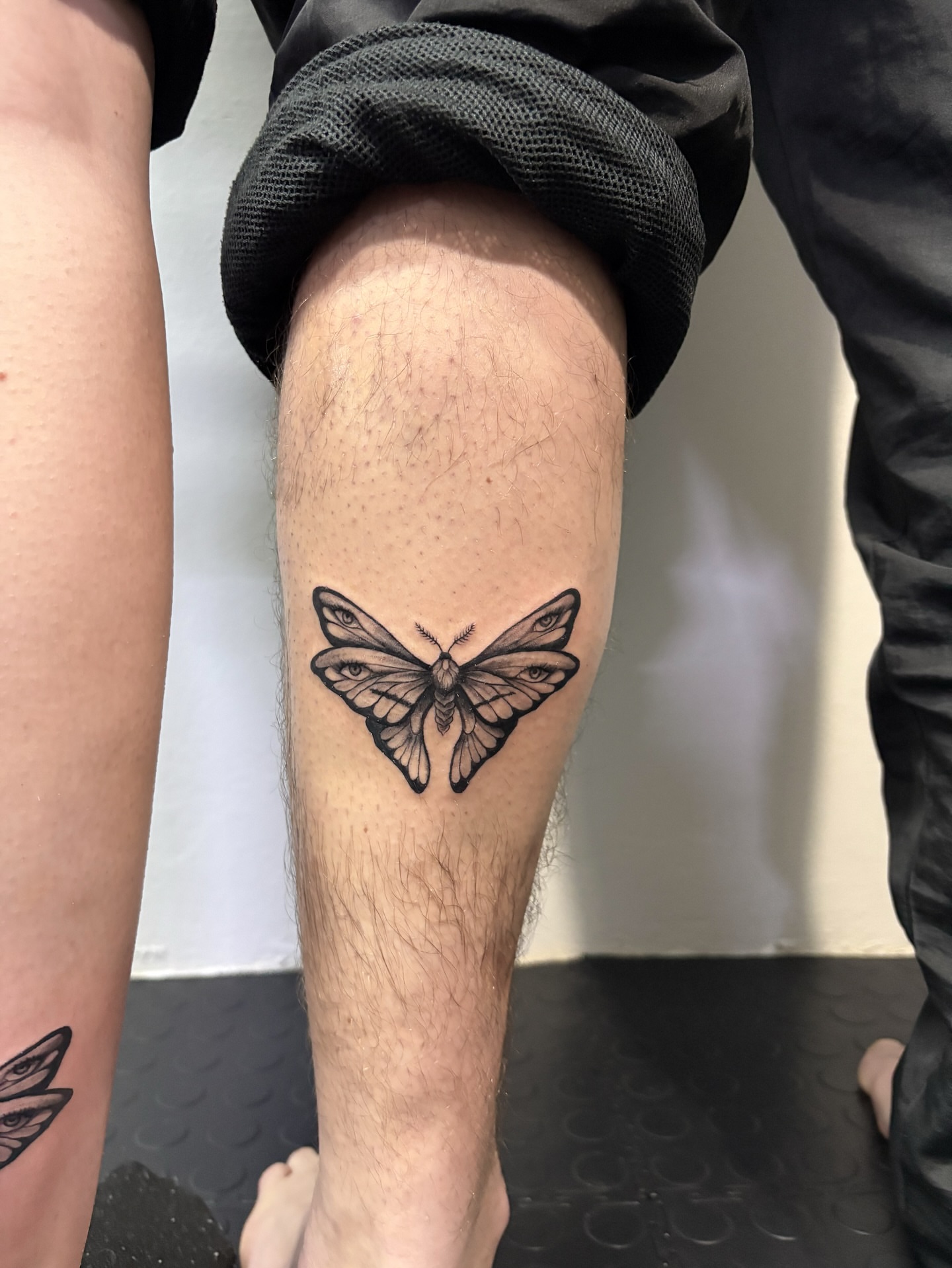 Moth black and grey tattoo on the leg by Art by Aimee