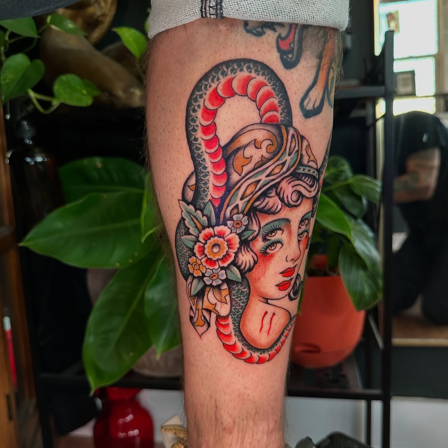 Woman with snake American traditional tattoo on the forearm by Max Peterson