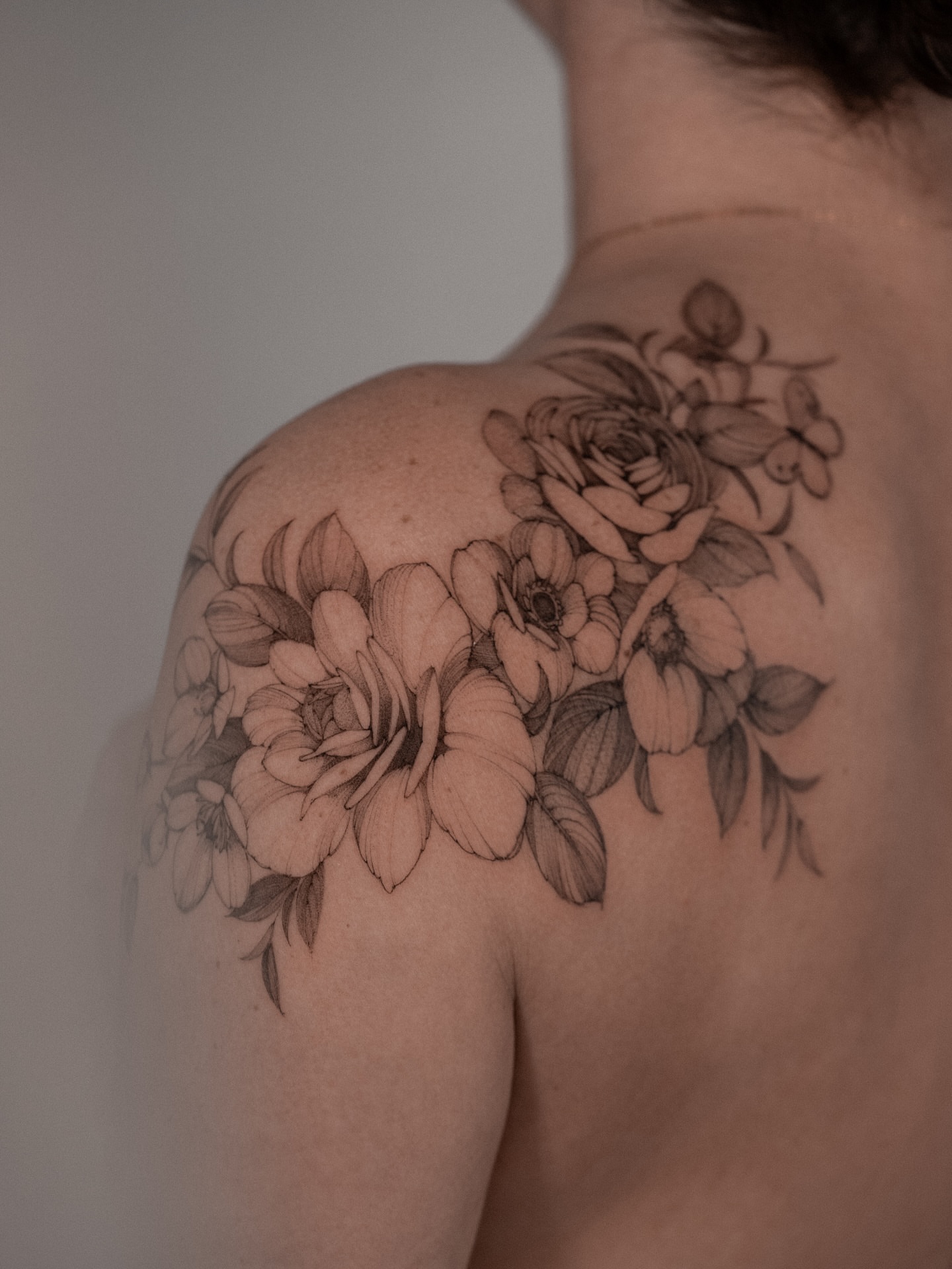 Floral bouquet black and grey tattoo on the shoulder by Mary Shekh