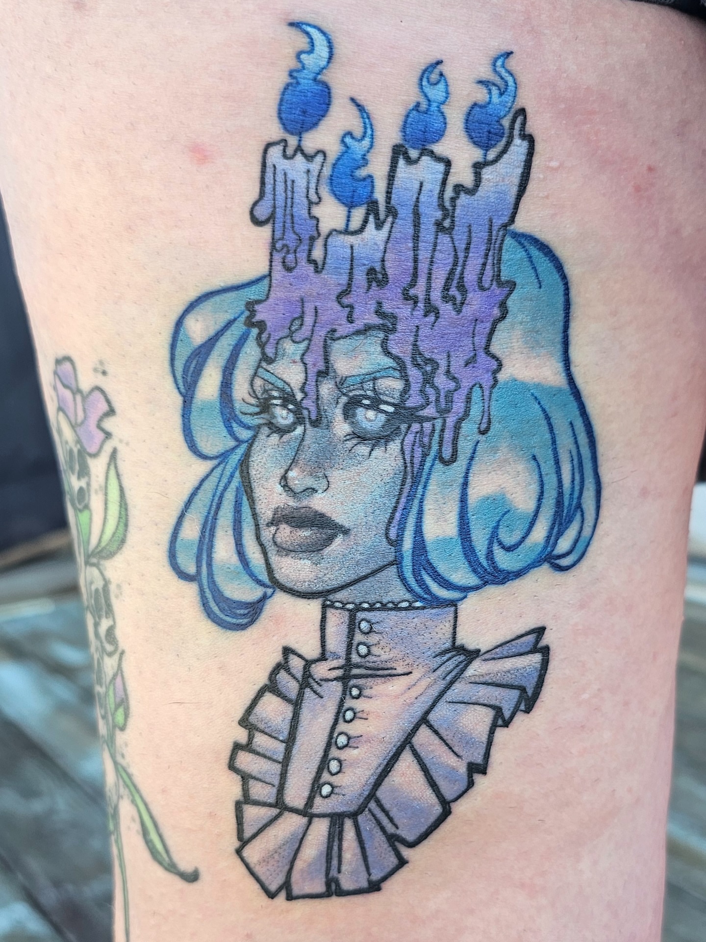 Blue-haired woman with candles illustrative tattoo on the thigh by Gabby