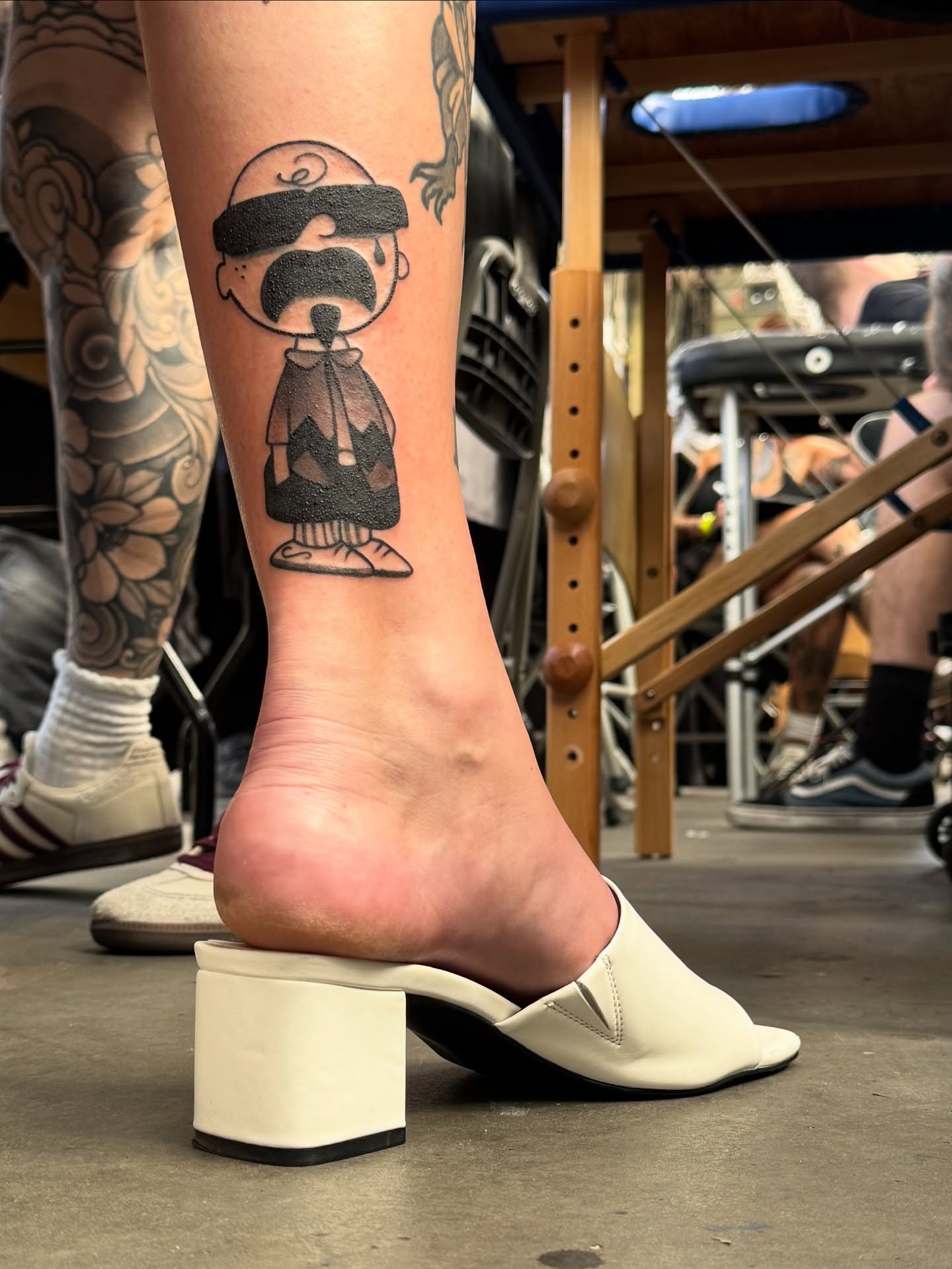 Charlie brown black and grey tattoo on the foot by John Black