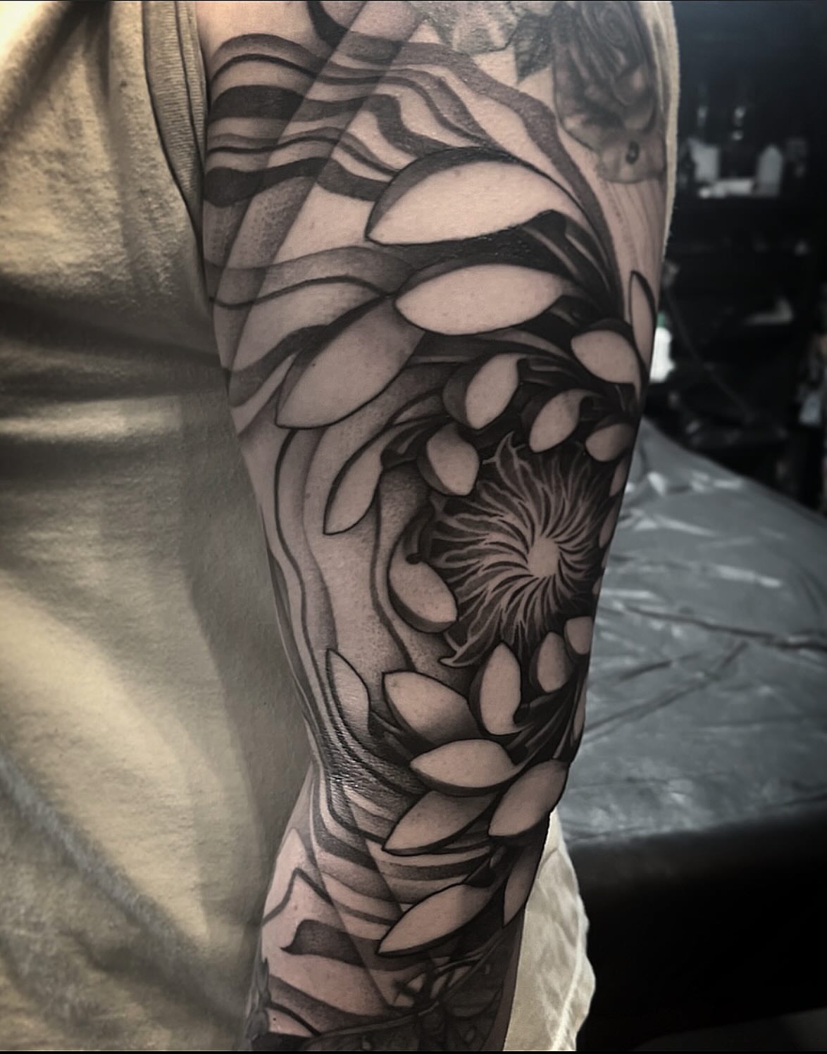 Flower geometric tattoo on the forearm by Jymi Calkins