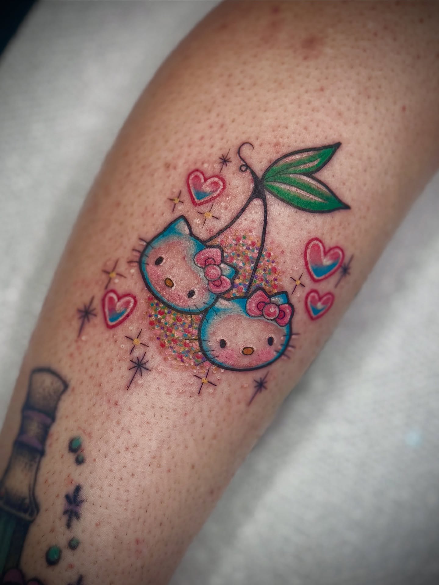 Hello Kitty dotwork tattoo on the forearm by K9