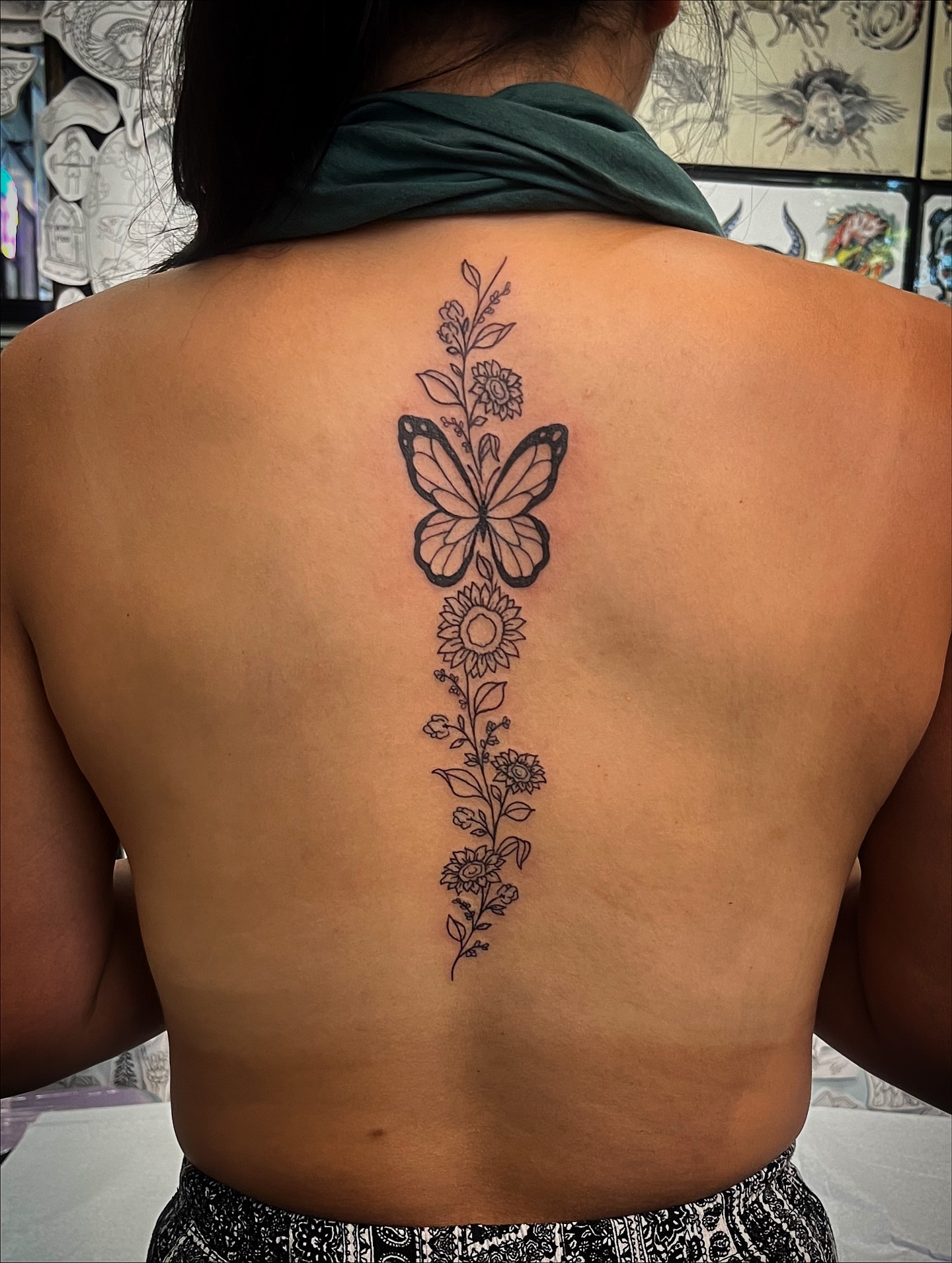 Butterfly and floral black and grey tattoo on the back by Laura