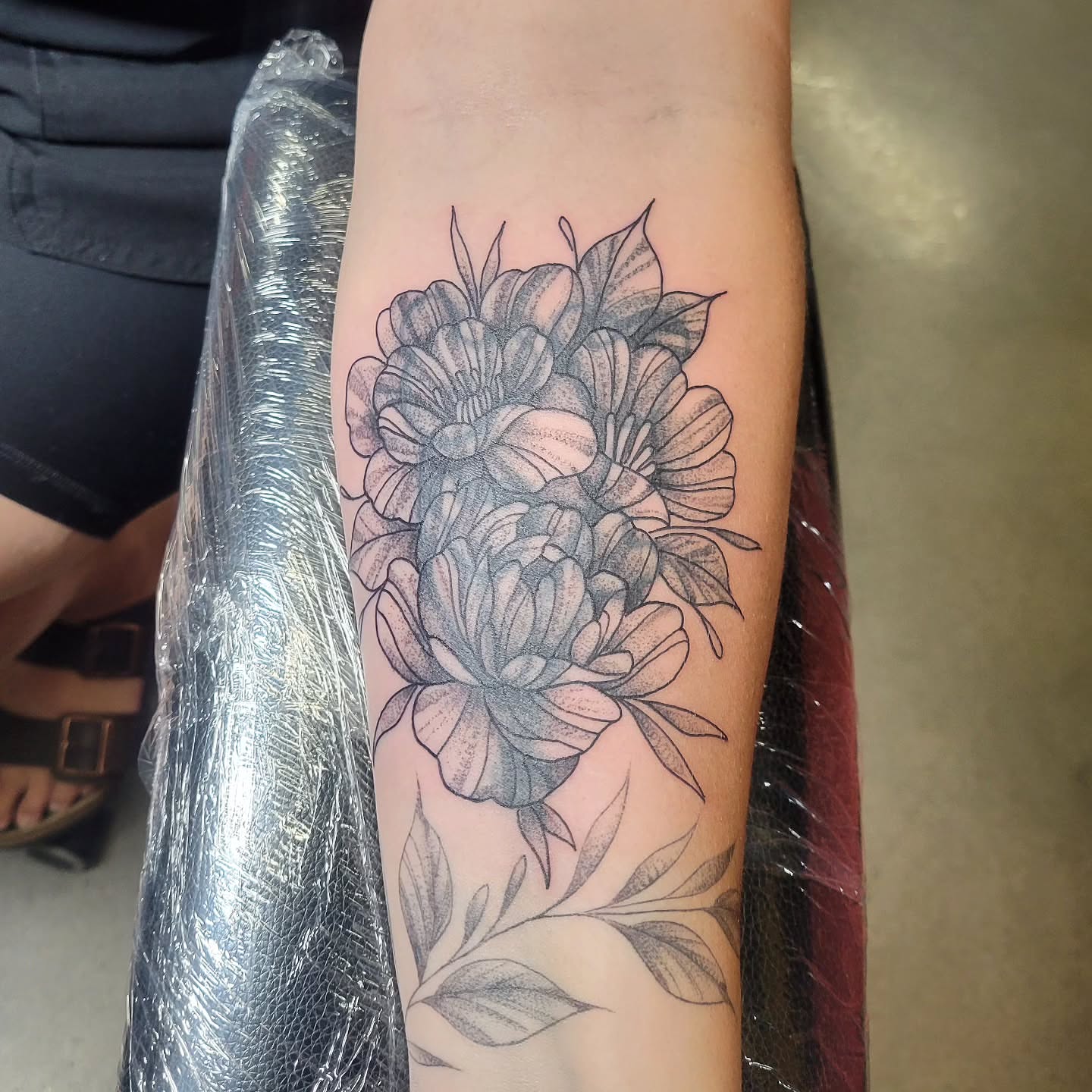 Peony flowers dotwork tattoo on the forearm by Aspen C