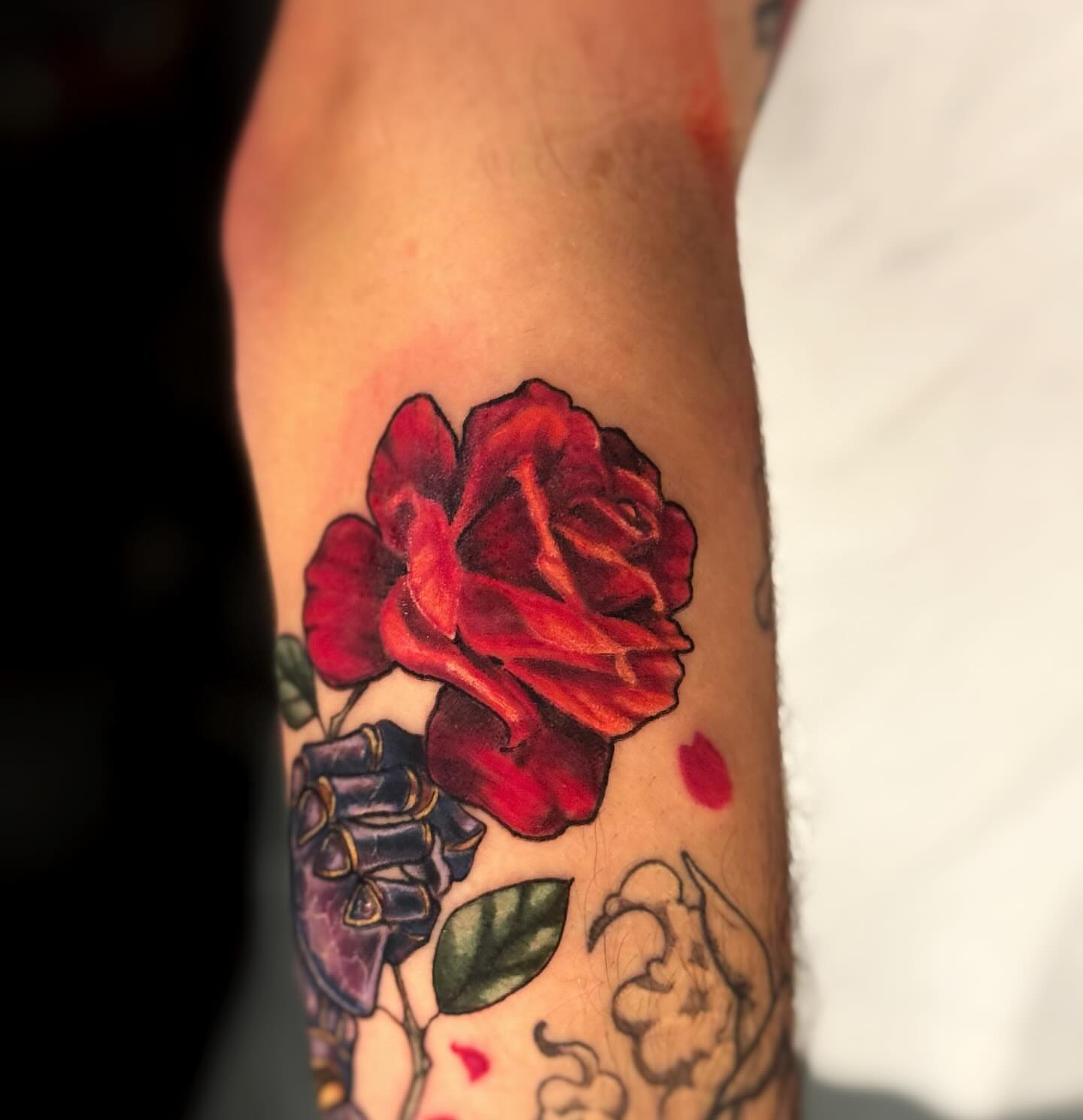 Red rose realism tattoo on the forearm by Anna Saveria