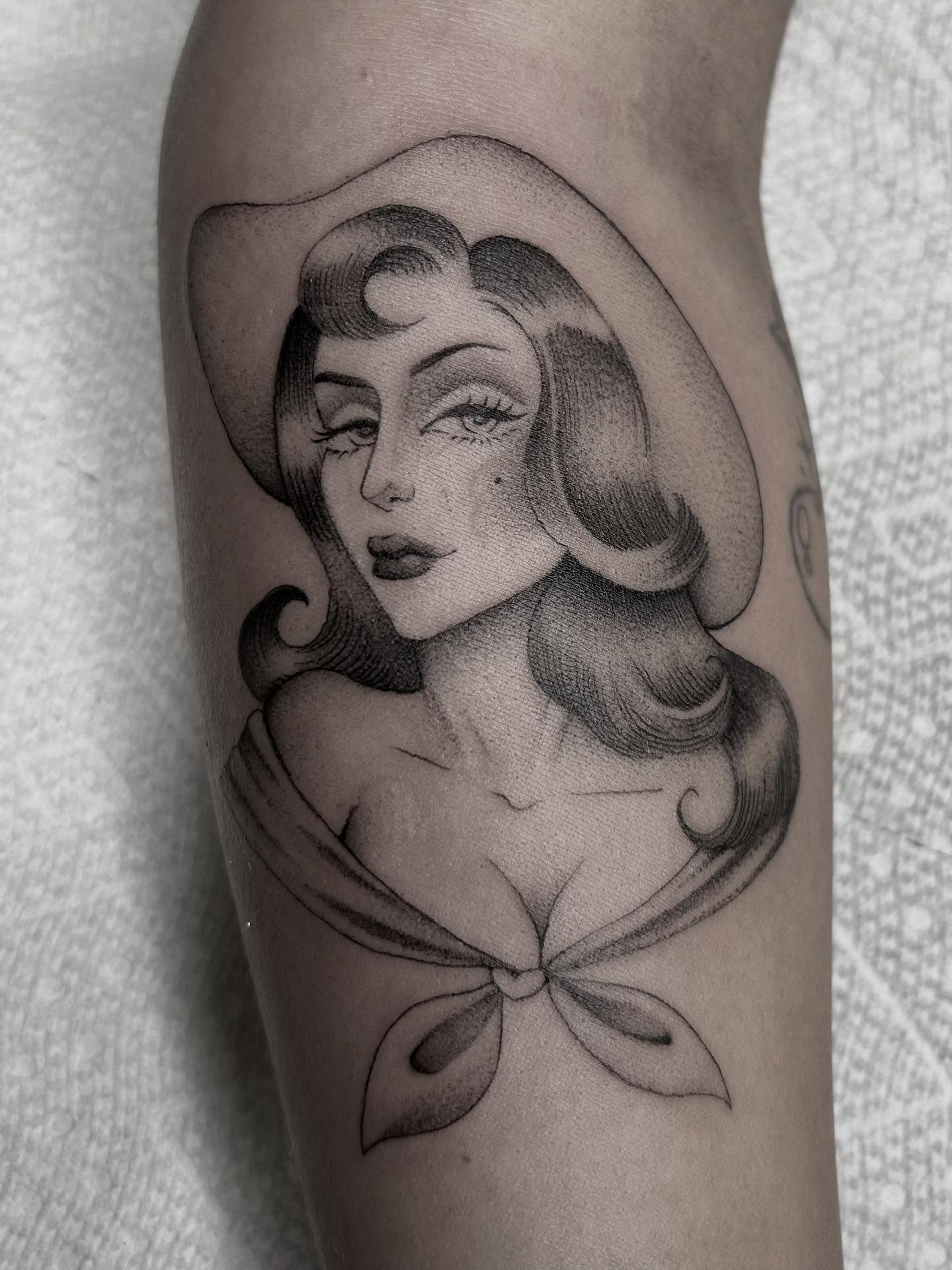 Woman with hat realism tattoo on the forearm by Olivia Fox