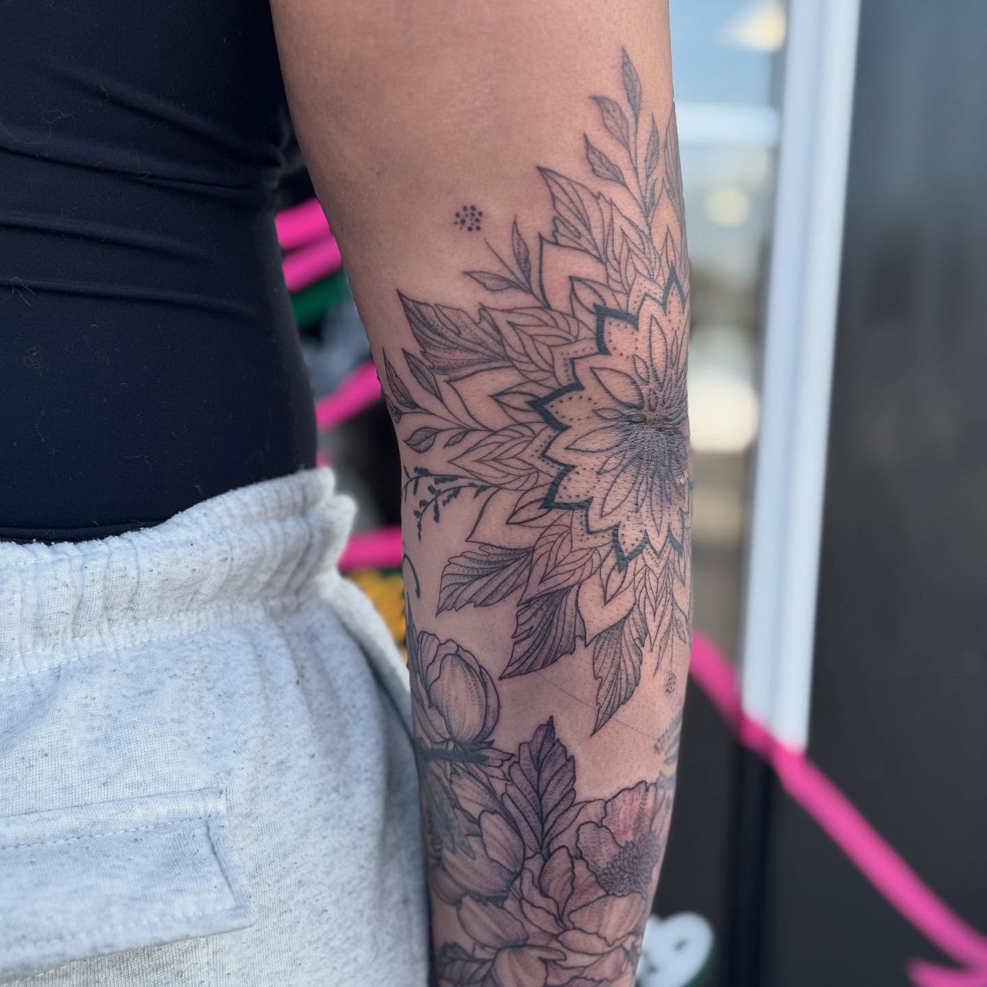 Floral bouquet black and grey tattoo on the forearm by Aura Noire
