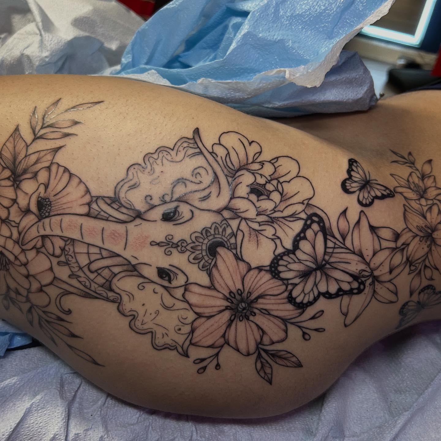 Elephant and floral ornamental tattoo on the thigh by Kells