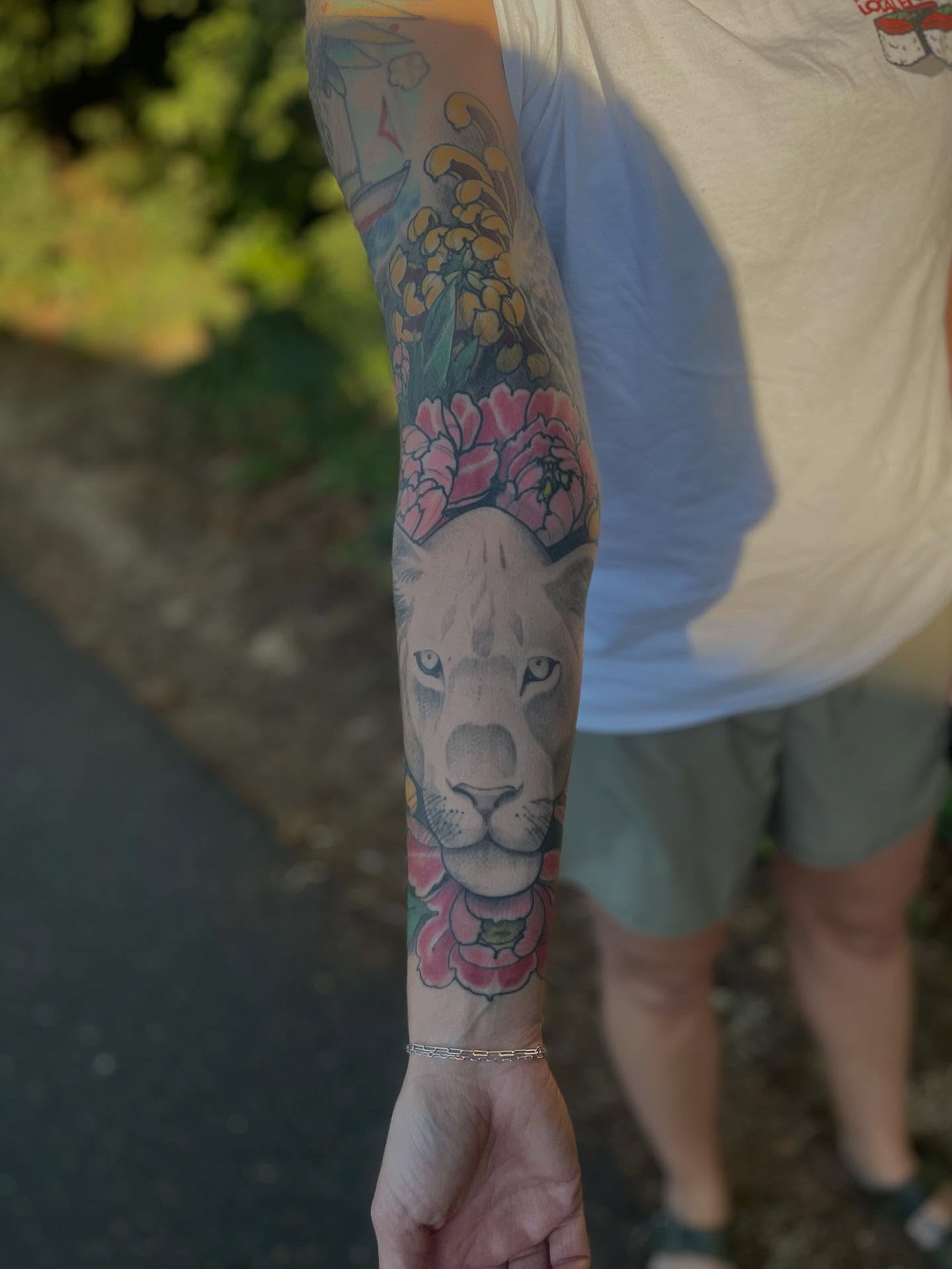 Lion with flowers American traditional tattoo on the forearm by ๐ต๐๐๐ ๐ฐ๐๐๐