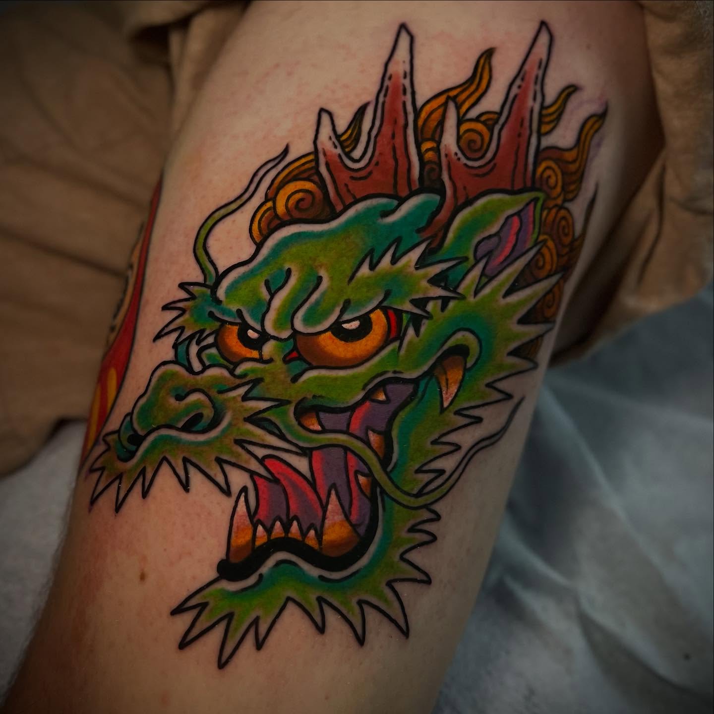 Dragon head American traditional tattoo on the forearm by Chris Romolini