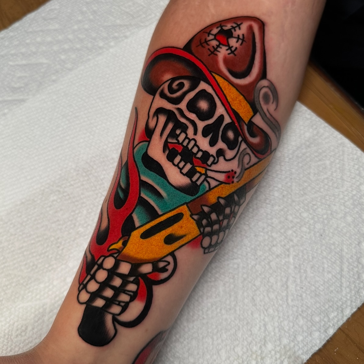 Skull with guitar American traditional tattoo on the forearm by Schyler Ames, Canal Fulton, Ohio