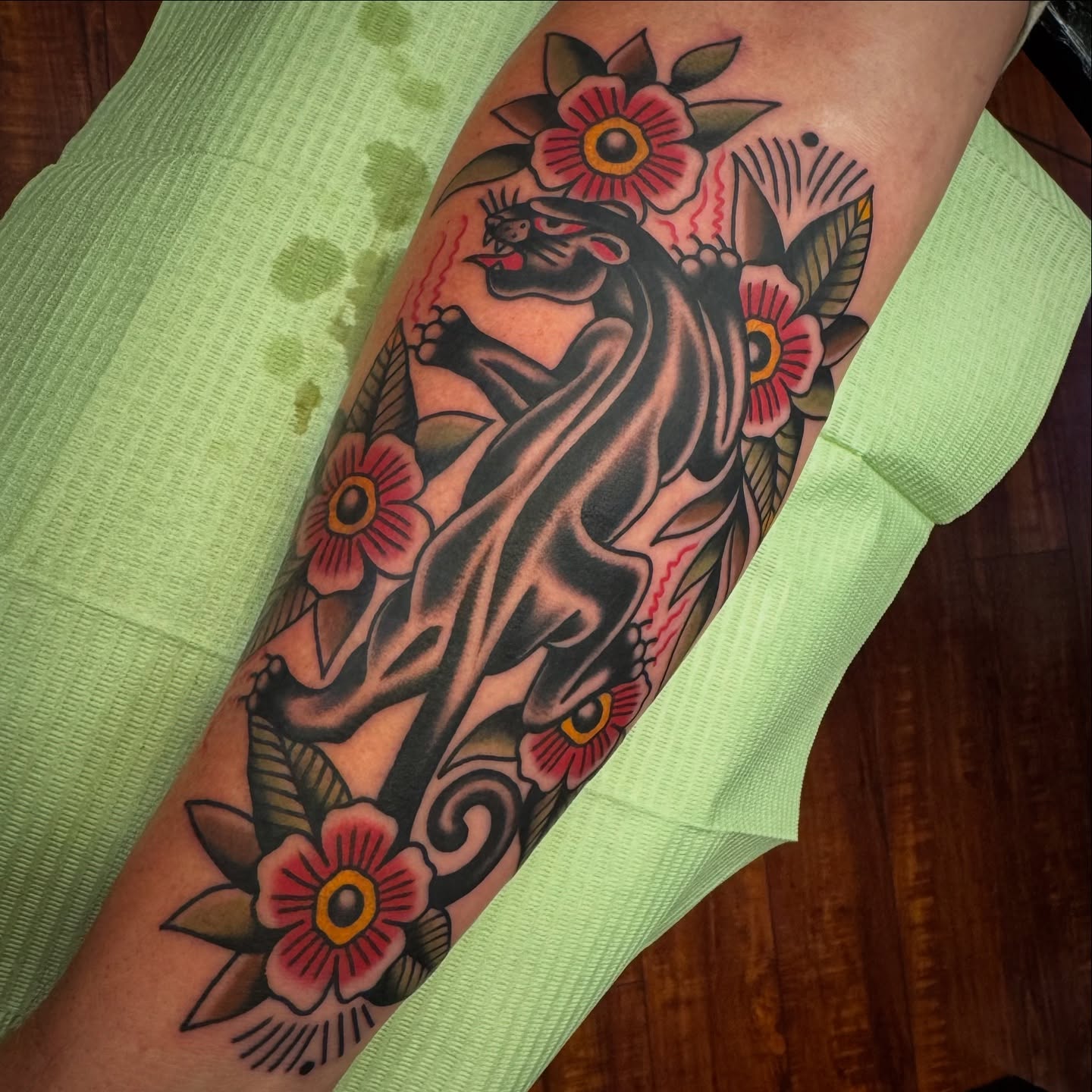 Panther and flowers American traditional tattoo on the forearm by Rogelio Robles