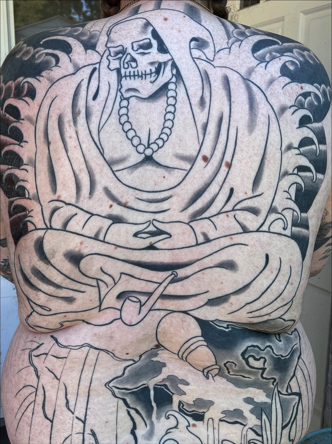 Meditating skeleton American traditional tattoo on the back by TYP 419, Toledo, Ohio