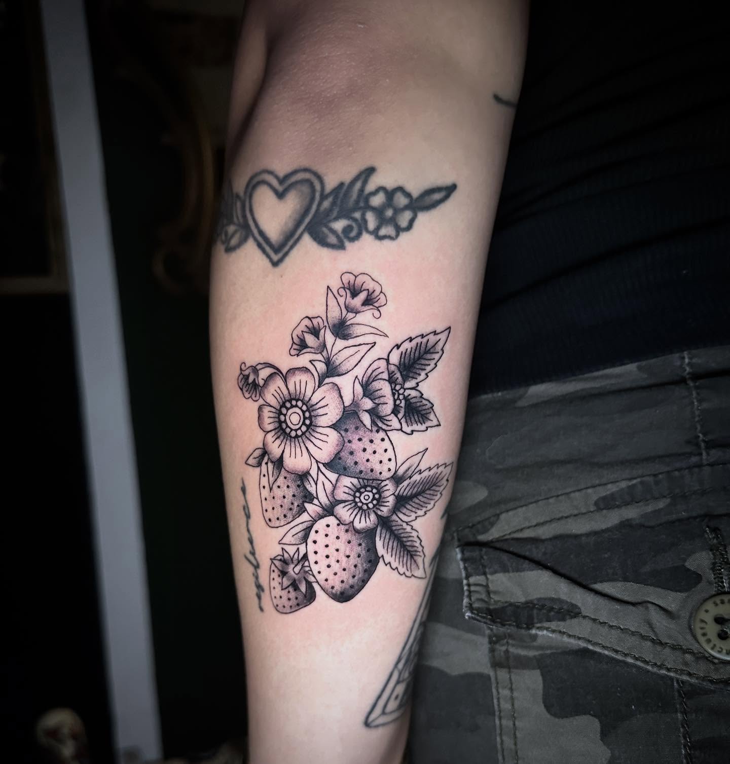 Flower bouquet black and grey tattoo on the forearm by Sierra
