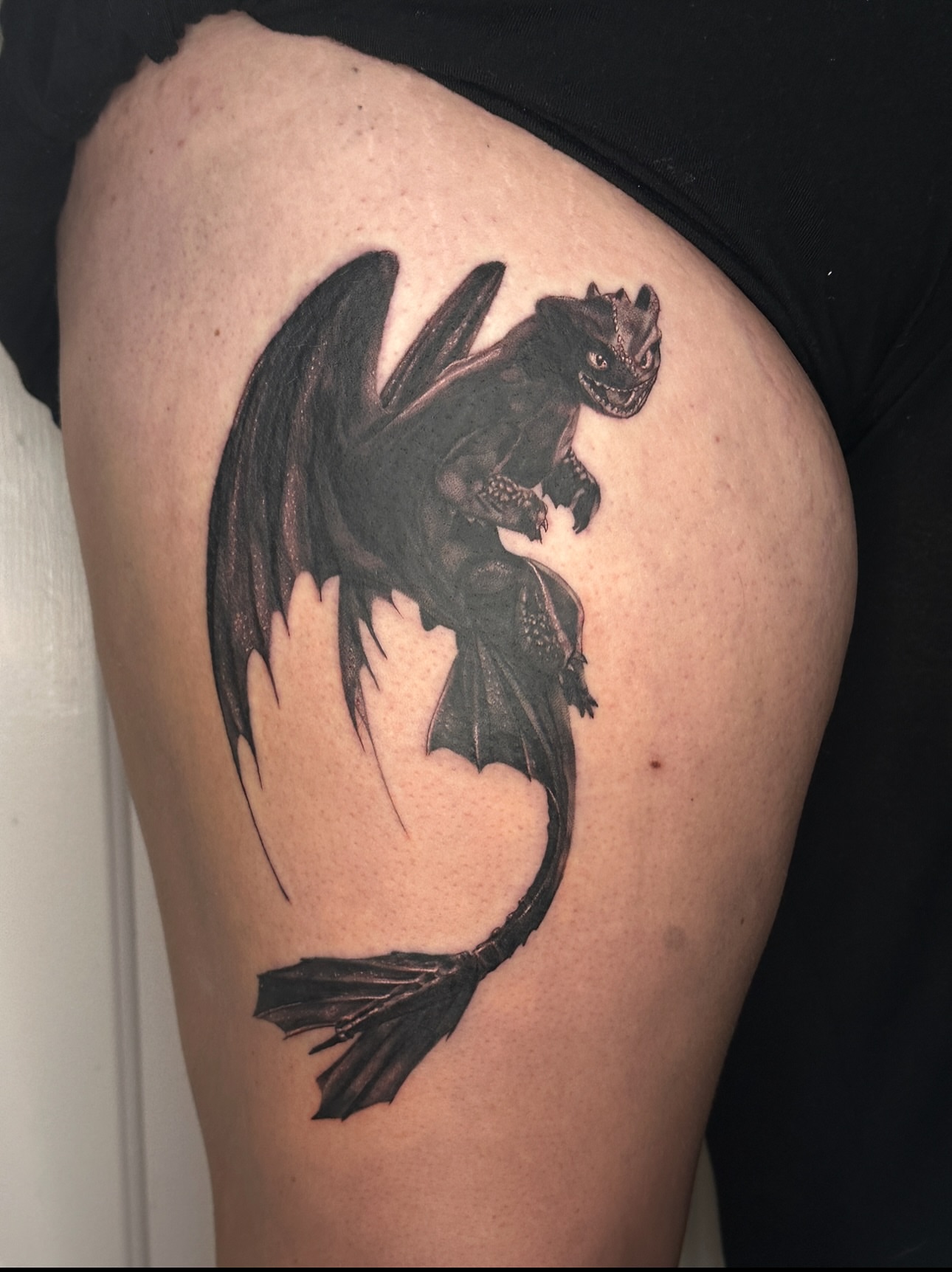 Dragon black and grey tattoo on the thigh by Nashville Tattoo Artist - Nicolette Madlyne