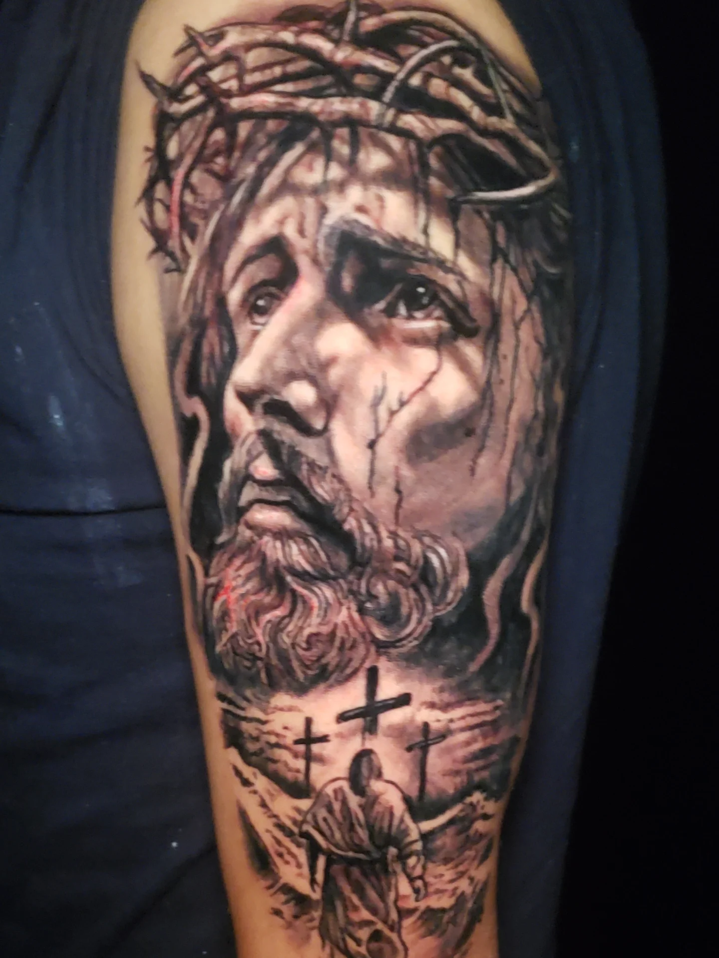 Religious figure realism tattoo on the forearm by Bruce Riehl