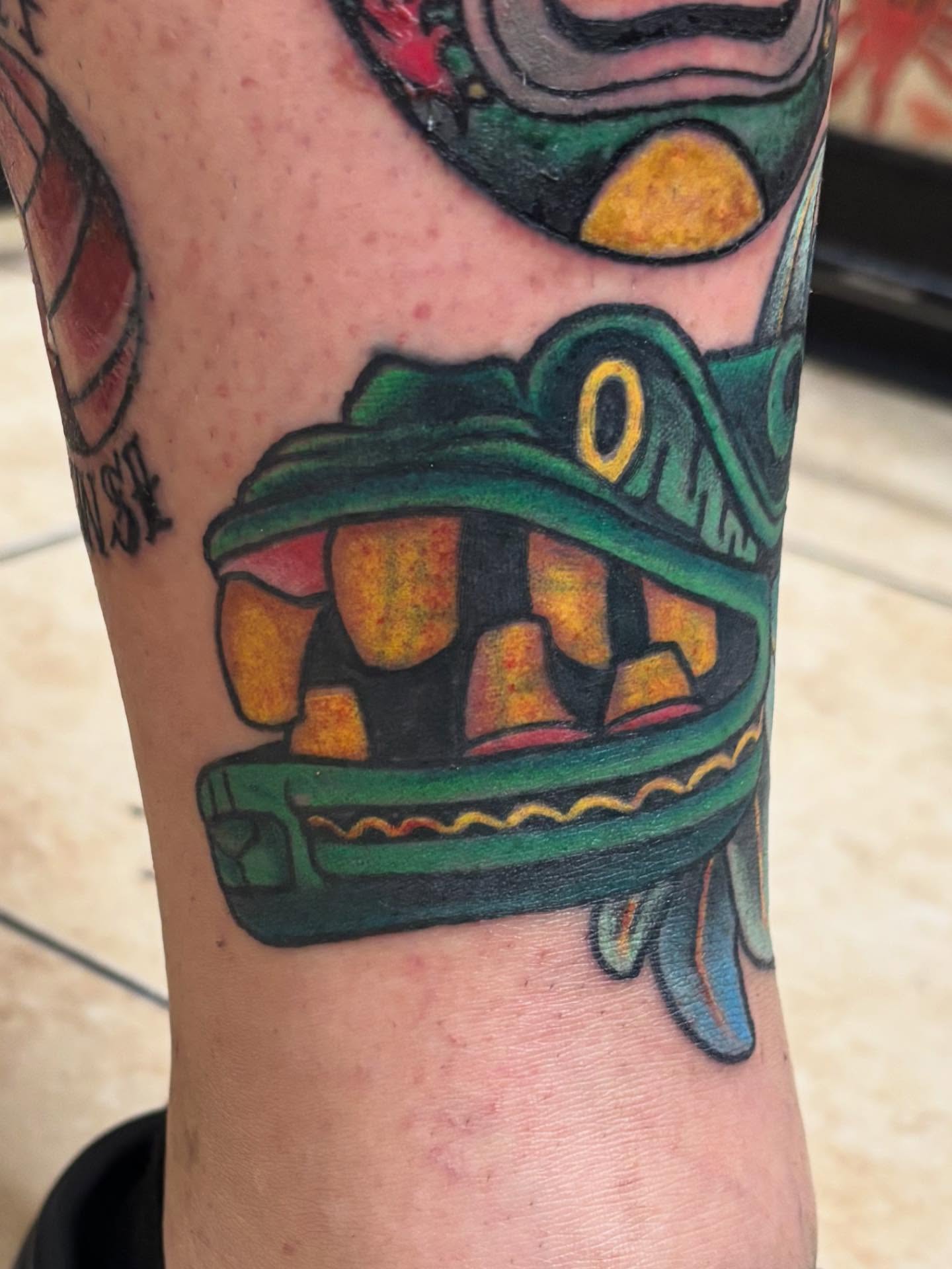 Mask American traditional tattoo on the forearm by Oscar Cuéllar (Kue-Yar)