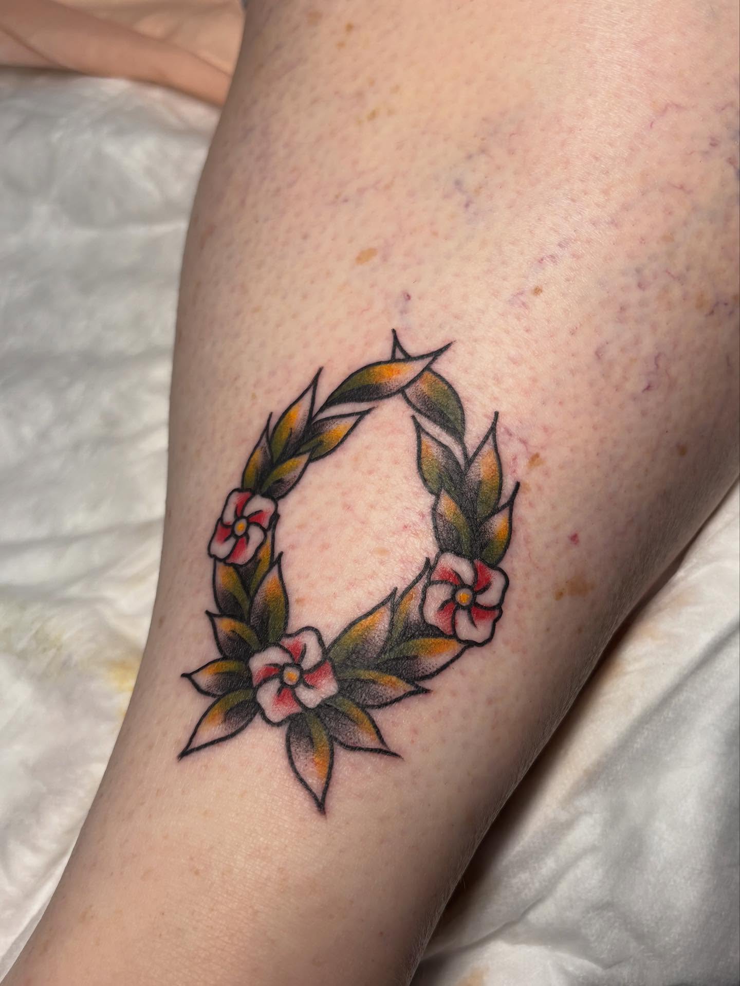 Floral wreath American traditional tattoo on the thigh by gia❤️‍🔥🎲, Maryville, Tennessee
