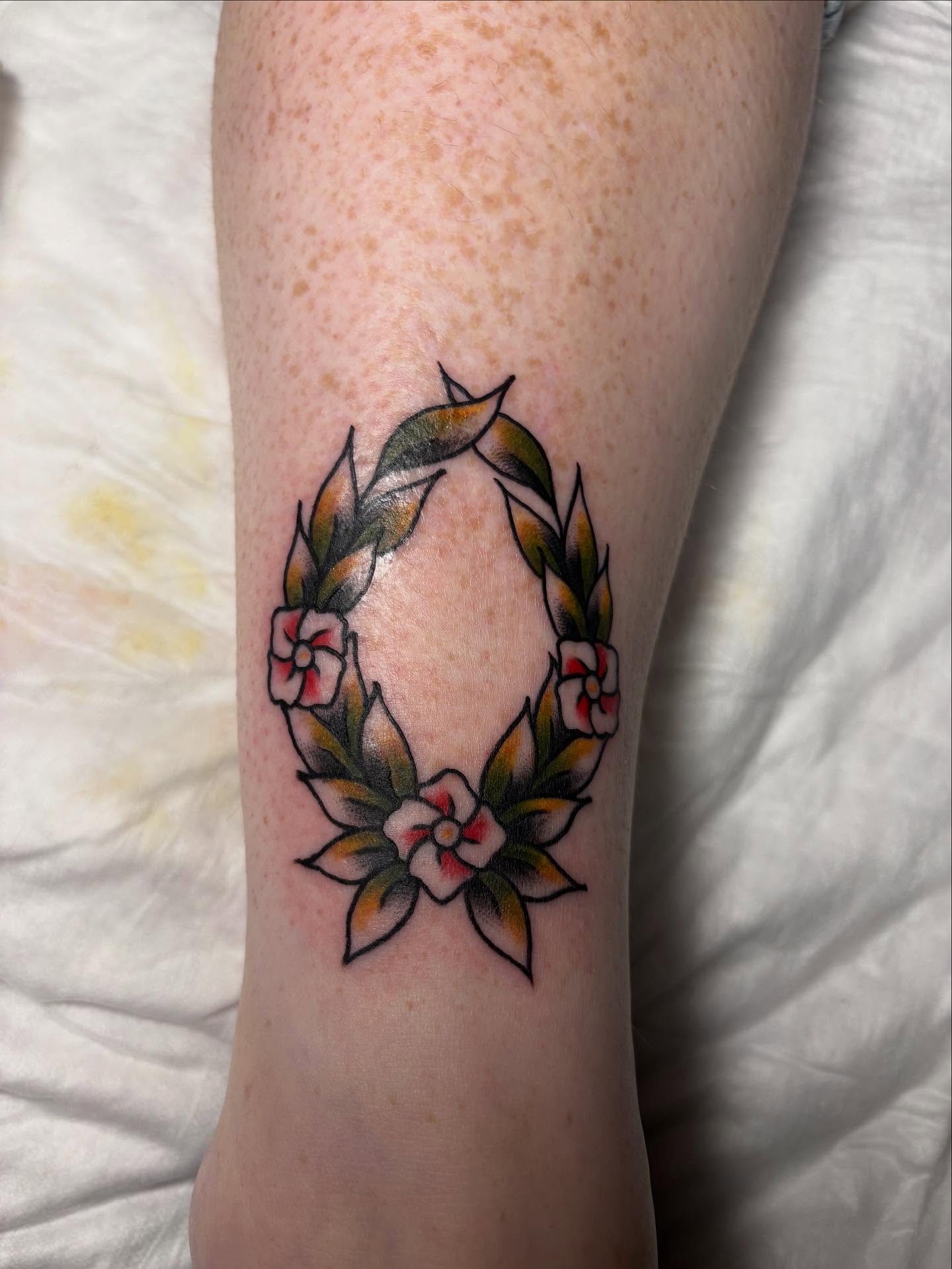 Floral wreath American traditional tattoo on the forearm by gia❤️‍🔥🎲, Maryville, Tennessee