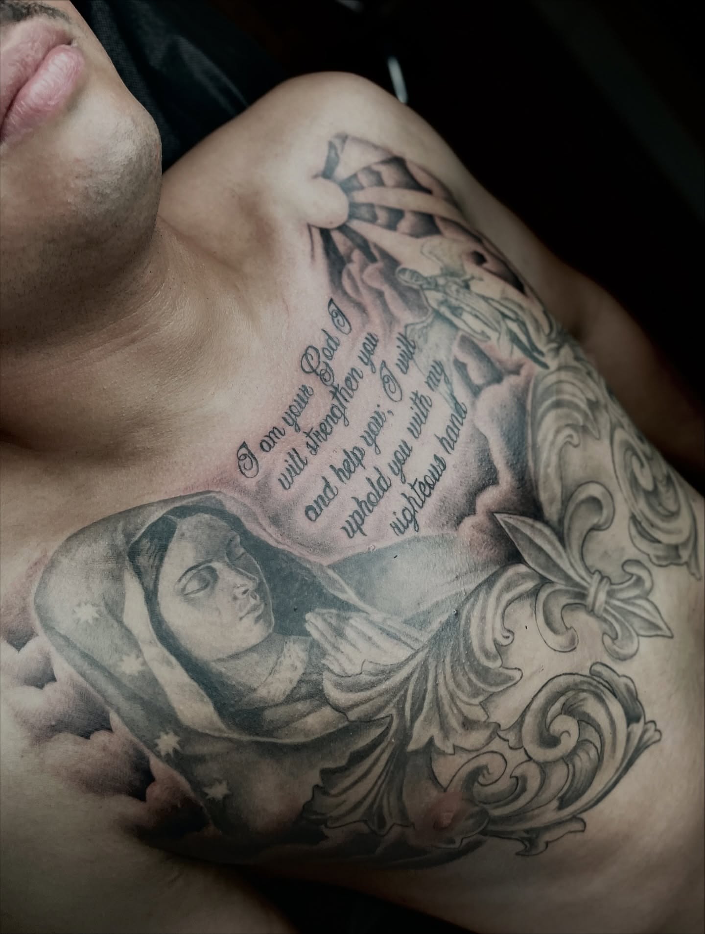 Religious figure black and grey tattoo on the chest by Koolz