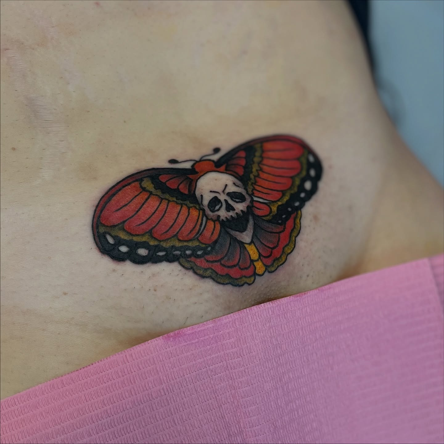 Butterfly with skull American traditional tattoo by Garden Glow Tattoo