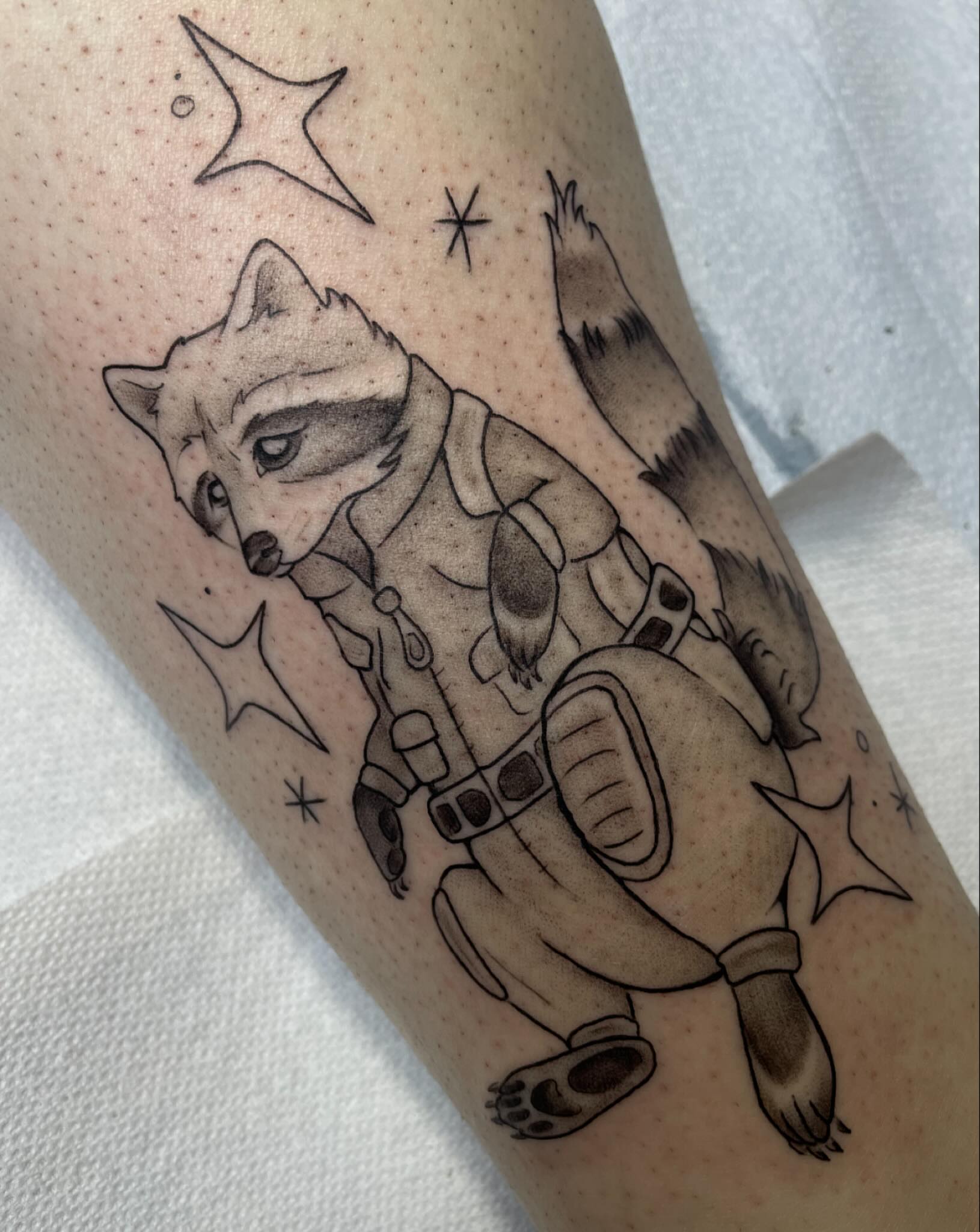 Raccoon astronaut realism tattoo on the forearm by Stevie Timmreck, Utica, Michigan