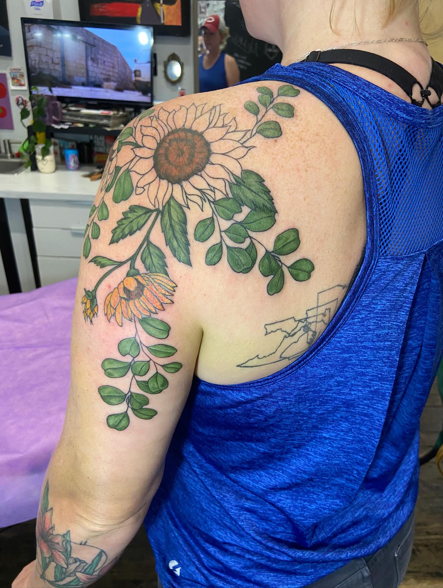 Sunflower and leaves realism tattoo on the shoulder by Dont Worry About It