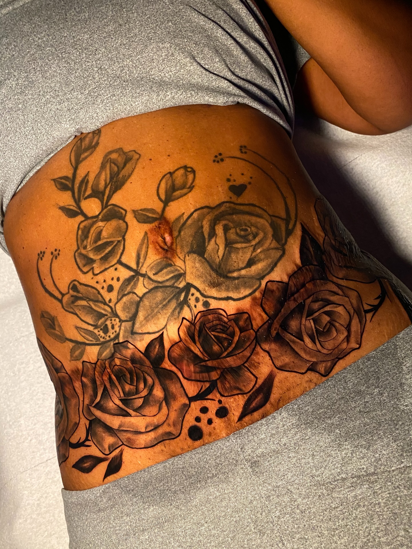 Roses black and grey tattoo on the thigh by Tattoo Artist