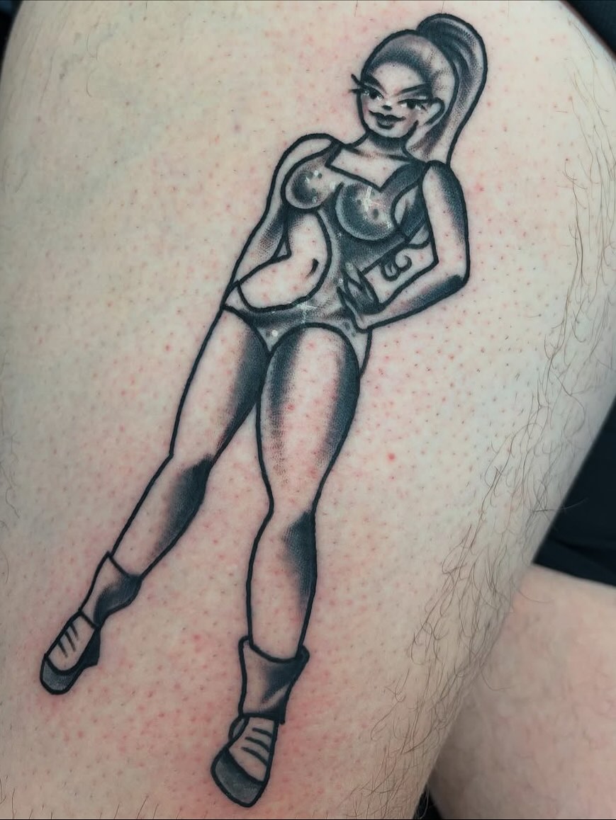 Female figure black and grey tattoo on the thigh by Nick