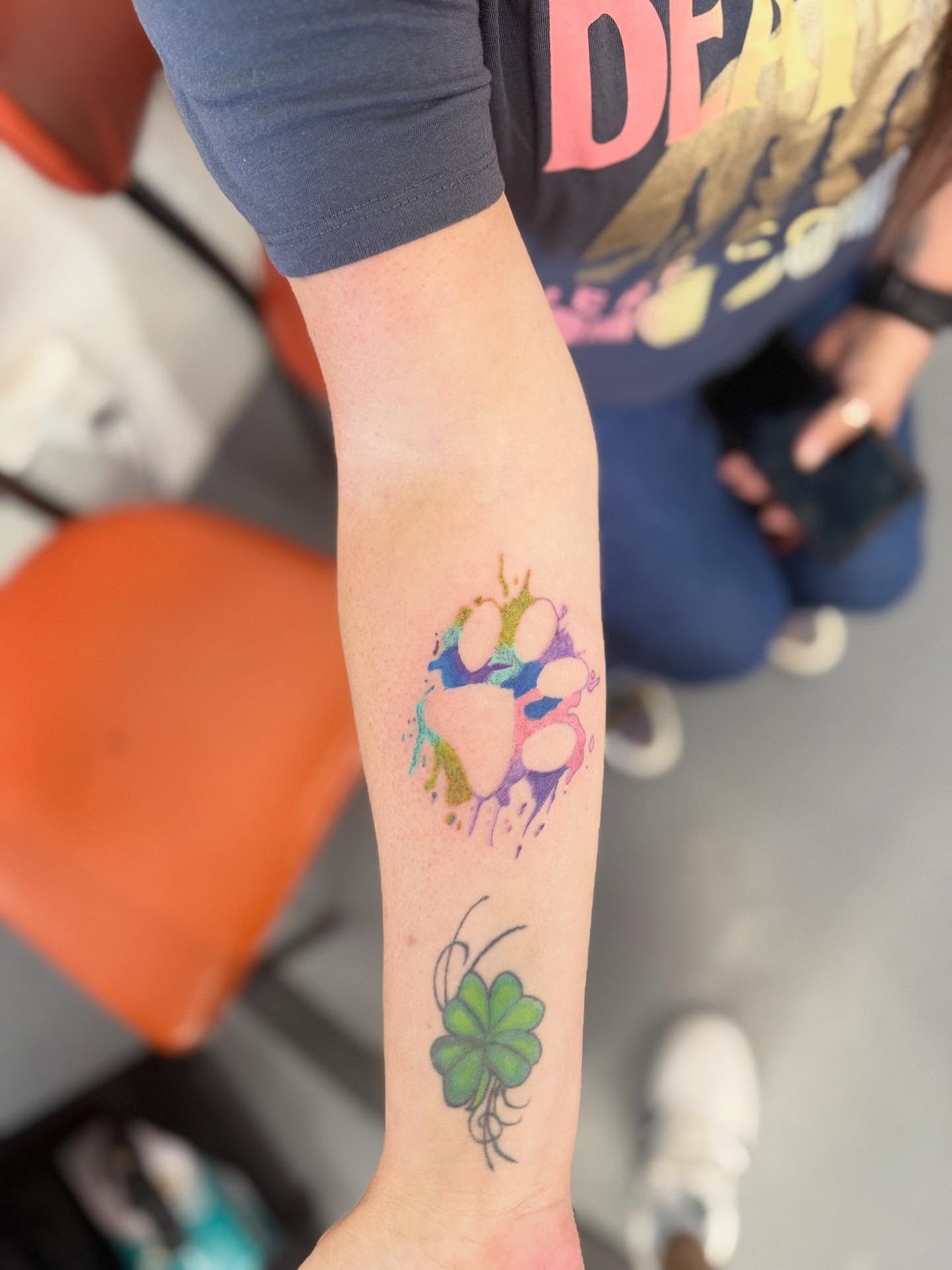 Watercolor paw print watercolor tattoo on the forearm by dotMX