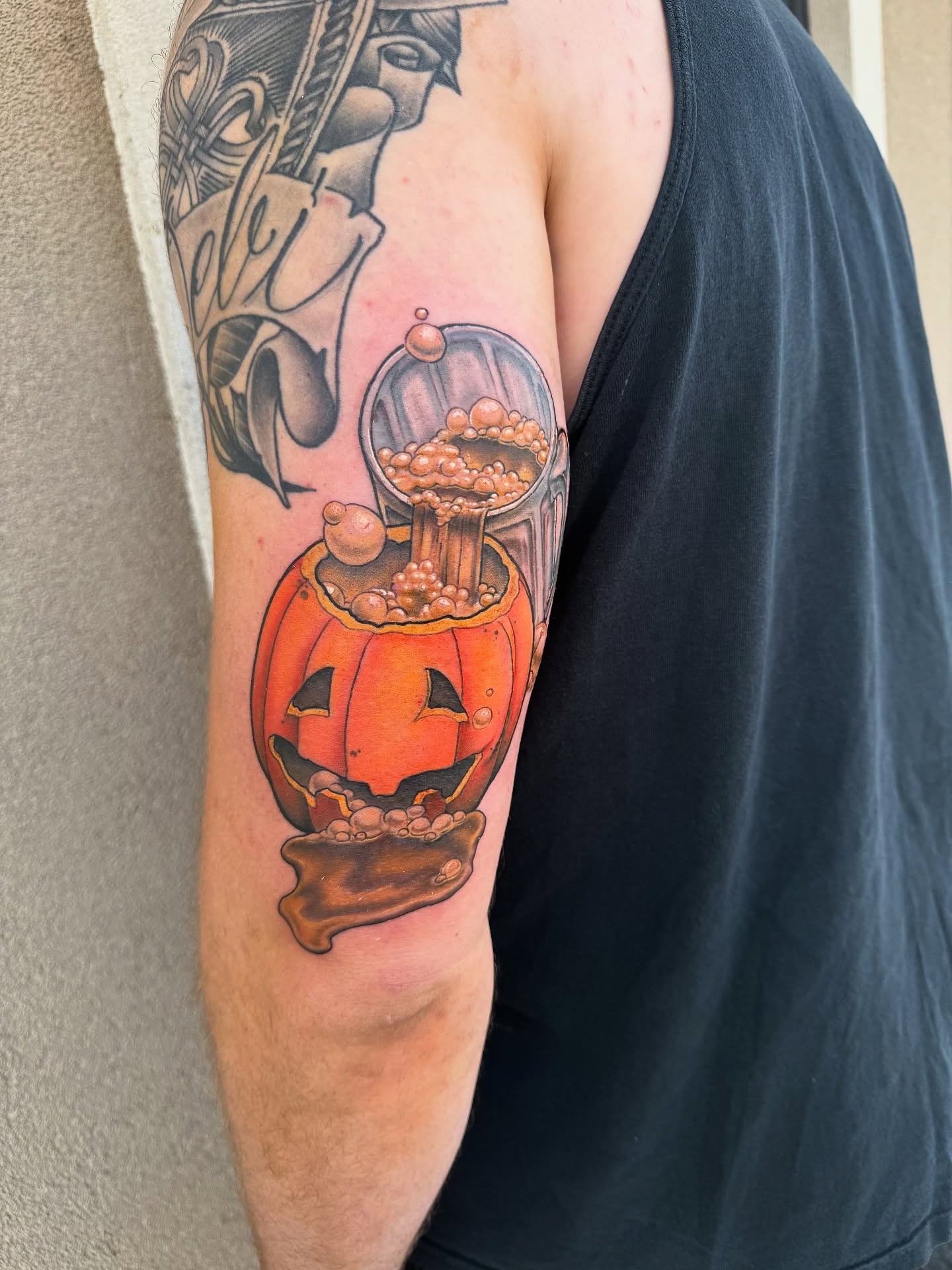 Pumpkin with candy realism tattoo on the forearm by Jake Kirk