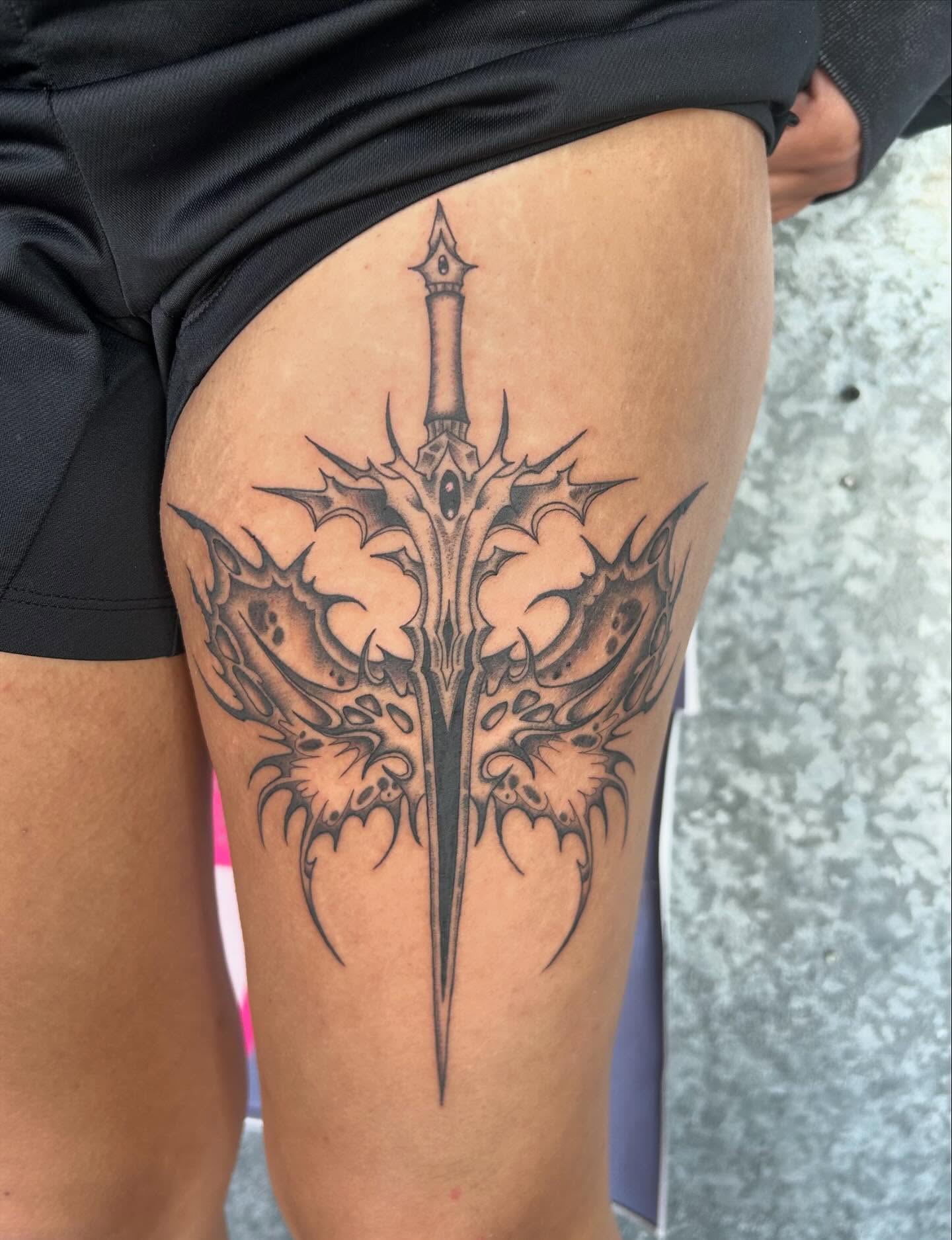 Sword and thorns black and grey tattoo on the thigh by Kerri Colello Sittenauer
