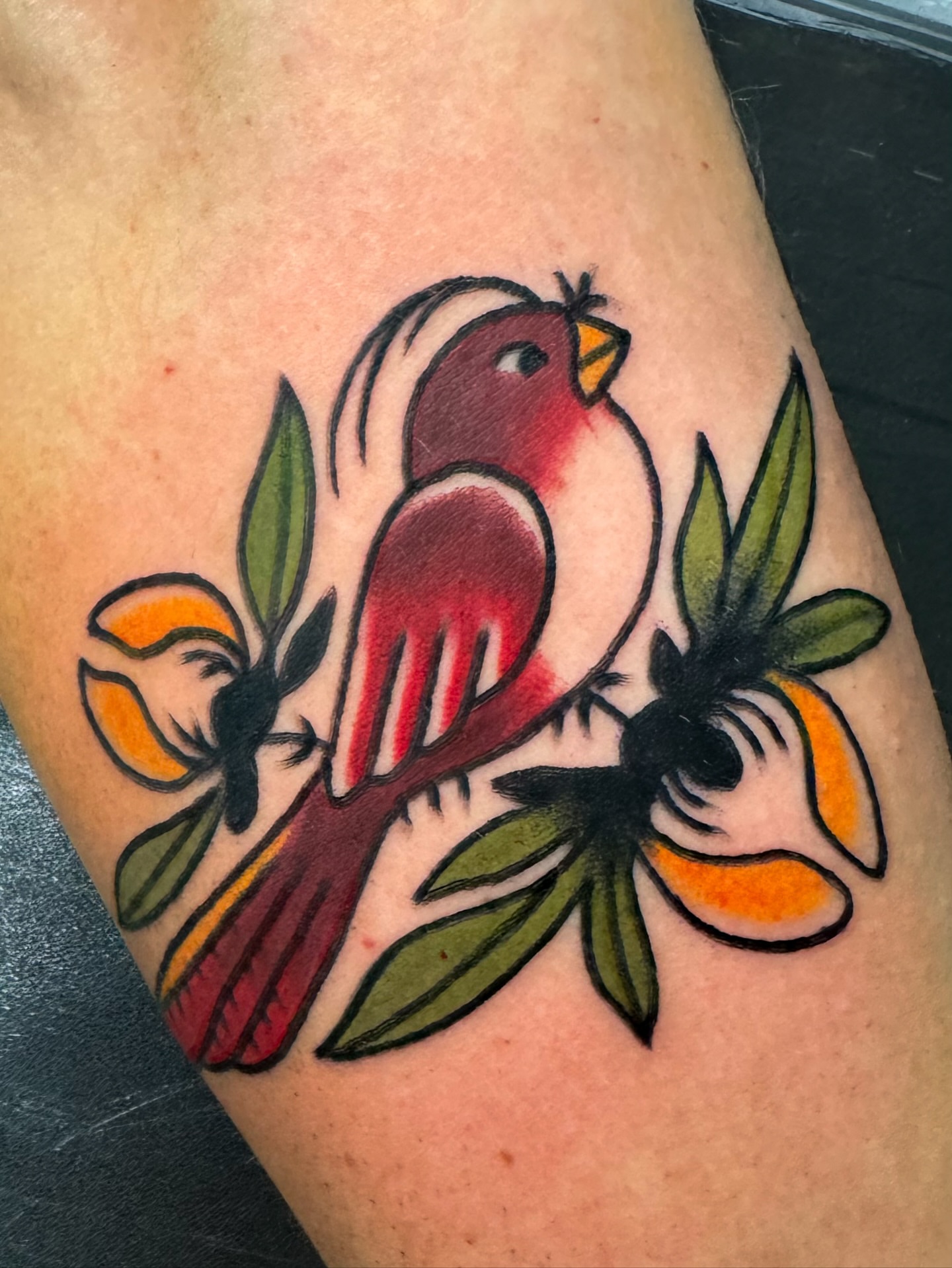 Bird and oranges American traditional tattoo on the thigh by Perrey