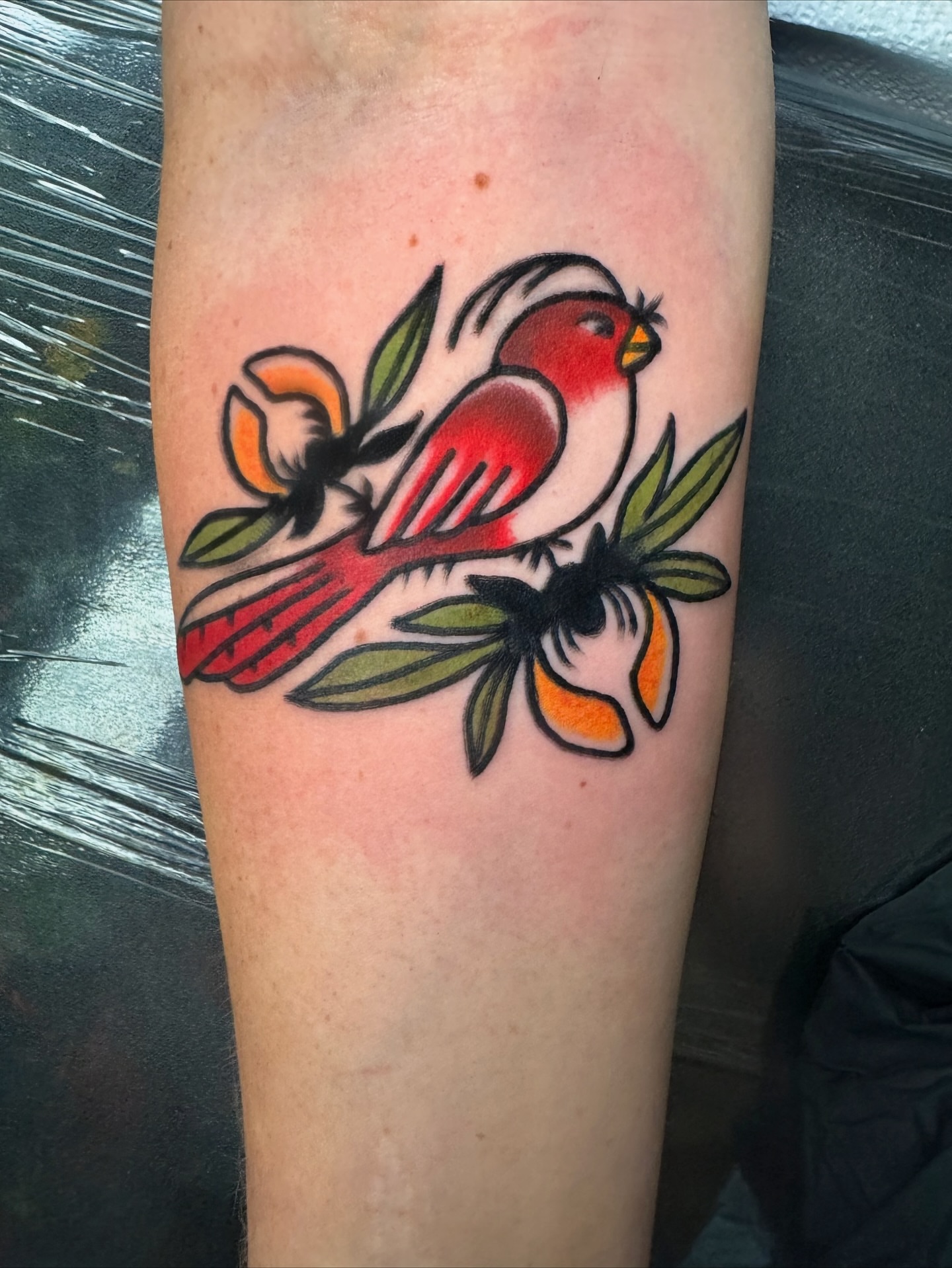 Bird and flowers American traditional tattoo on the forearm by Perrey