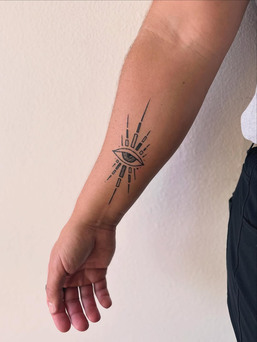 Eye with rays sketch tattoo on the forearm by Gaya