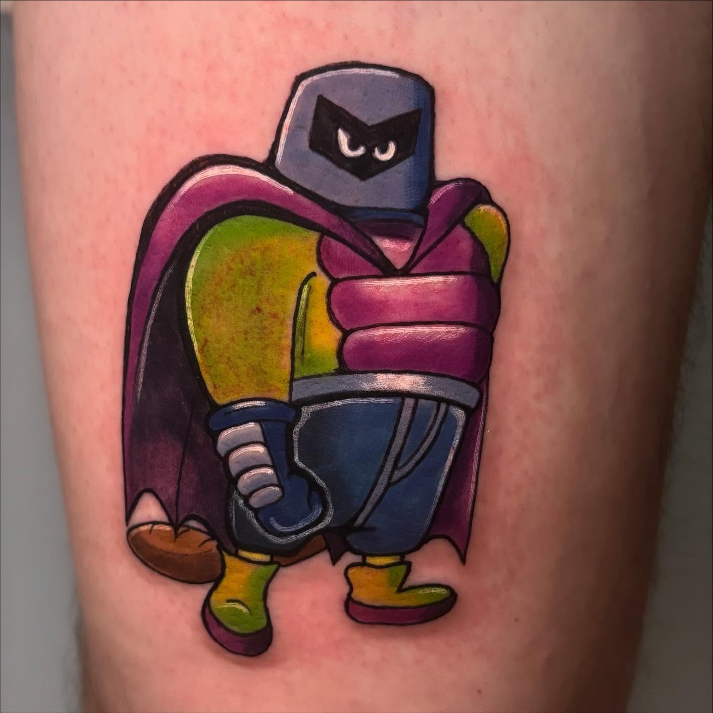 Masked character geometric tattoo on the thigh by Breanna Fraielli