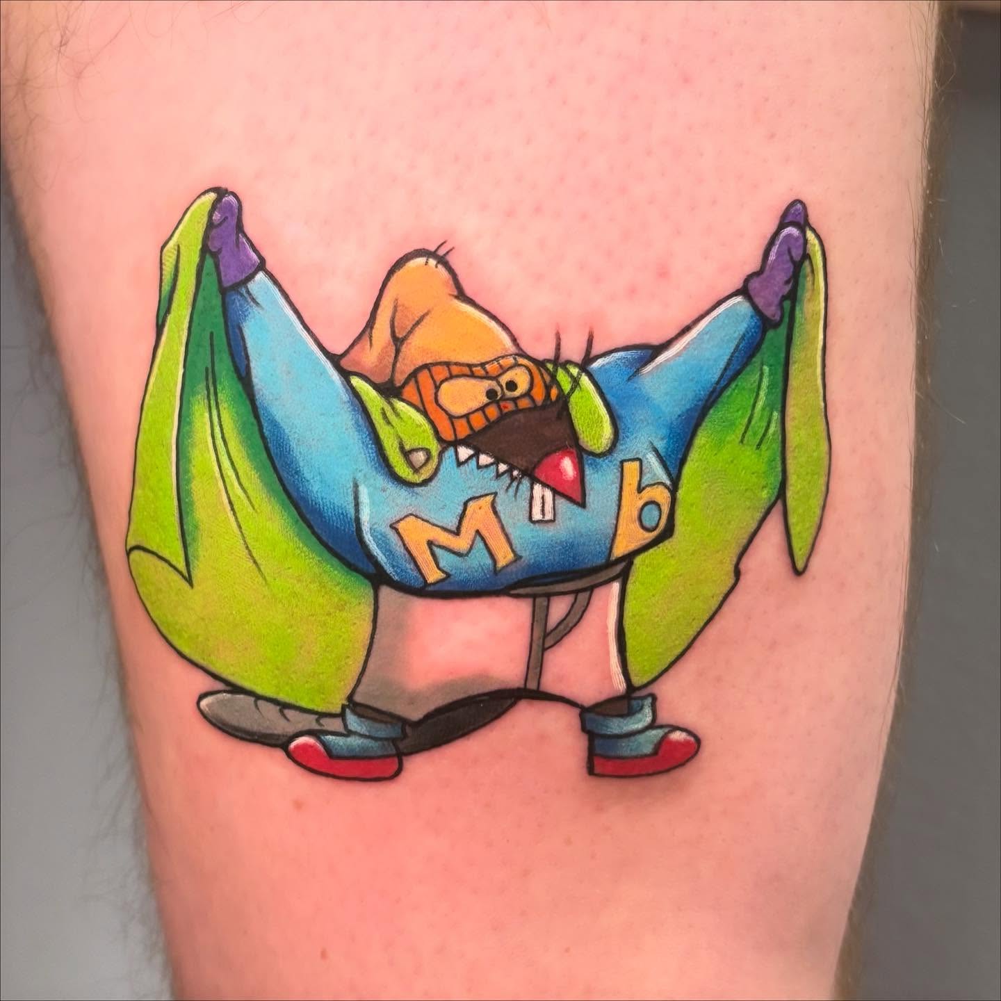 Cartoon character illustrative tattoo on the thigh by Breanna Fraielli