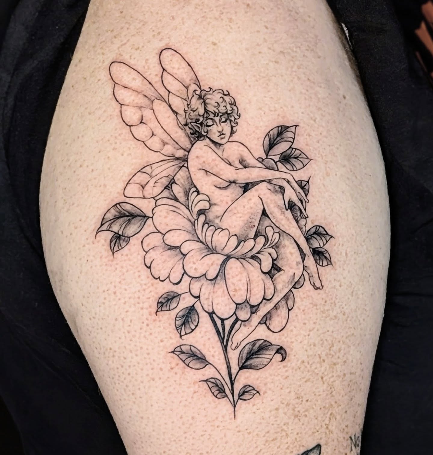 Fairy on flower dotwork tattoo on the thigh by Shannon