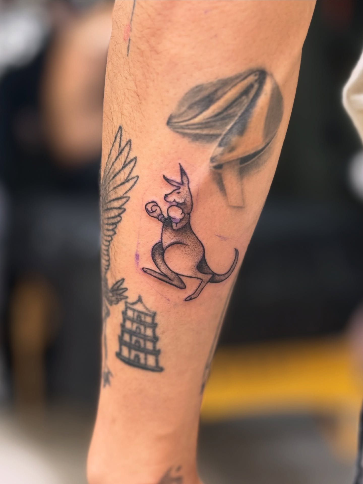 Kangaroo and UFO black and grey tattoo on the forearm by Marie Amor🌙