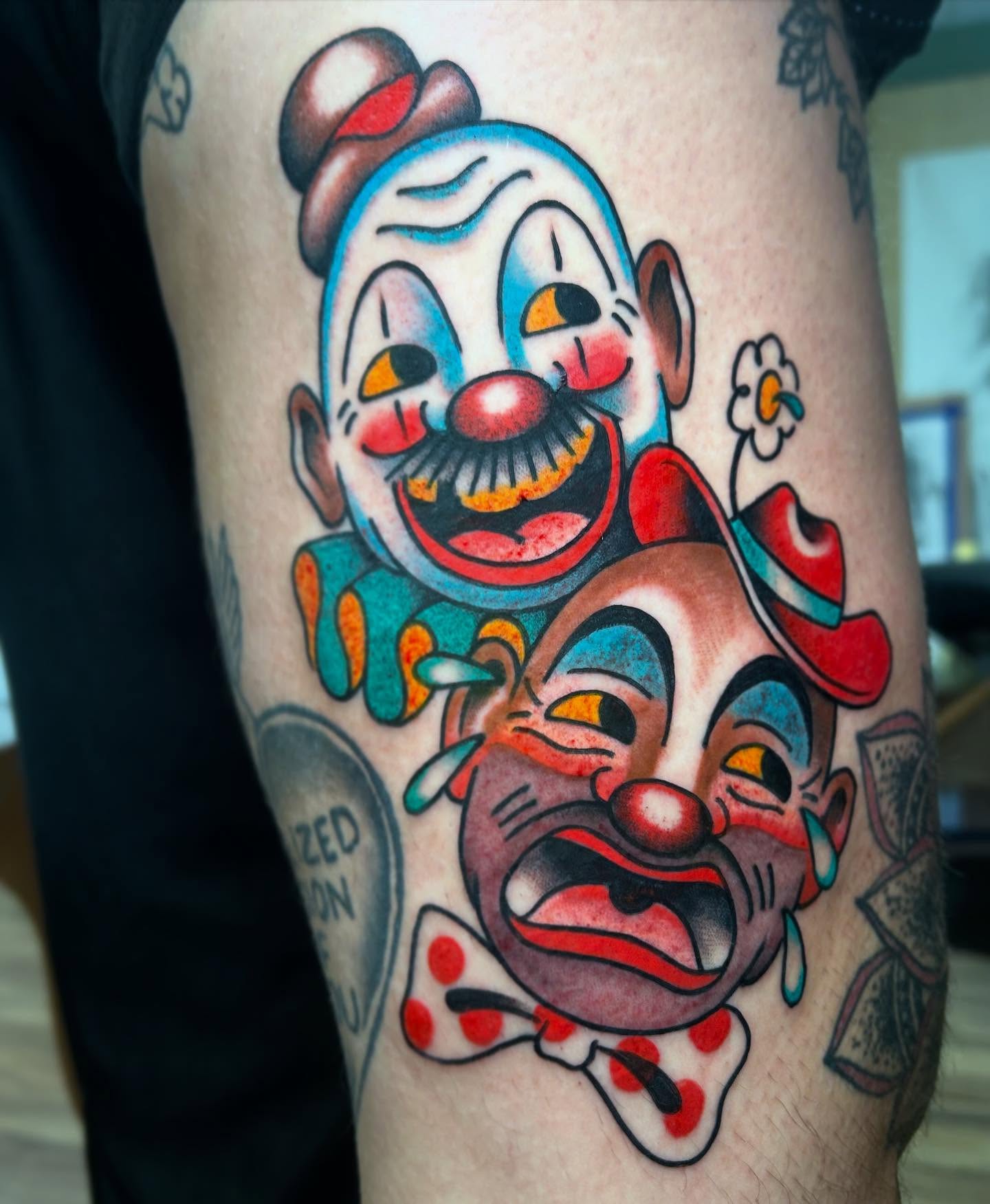 Clown faces American traditional tattoo on the forearm by Katie Dexter, Des Moines, Iowa