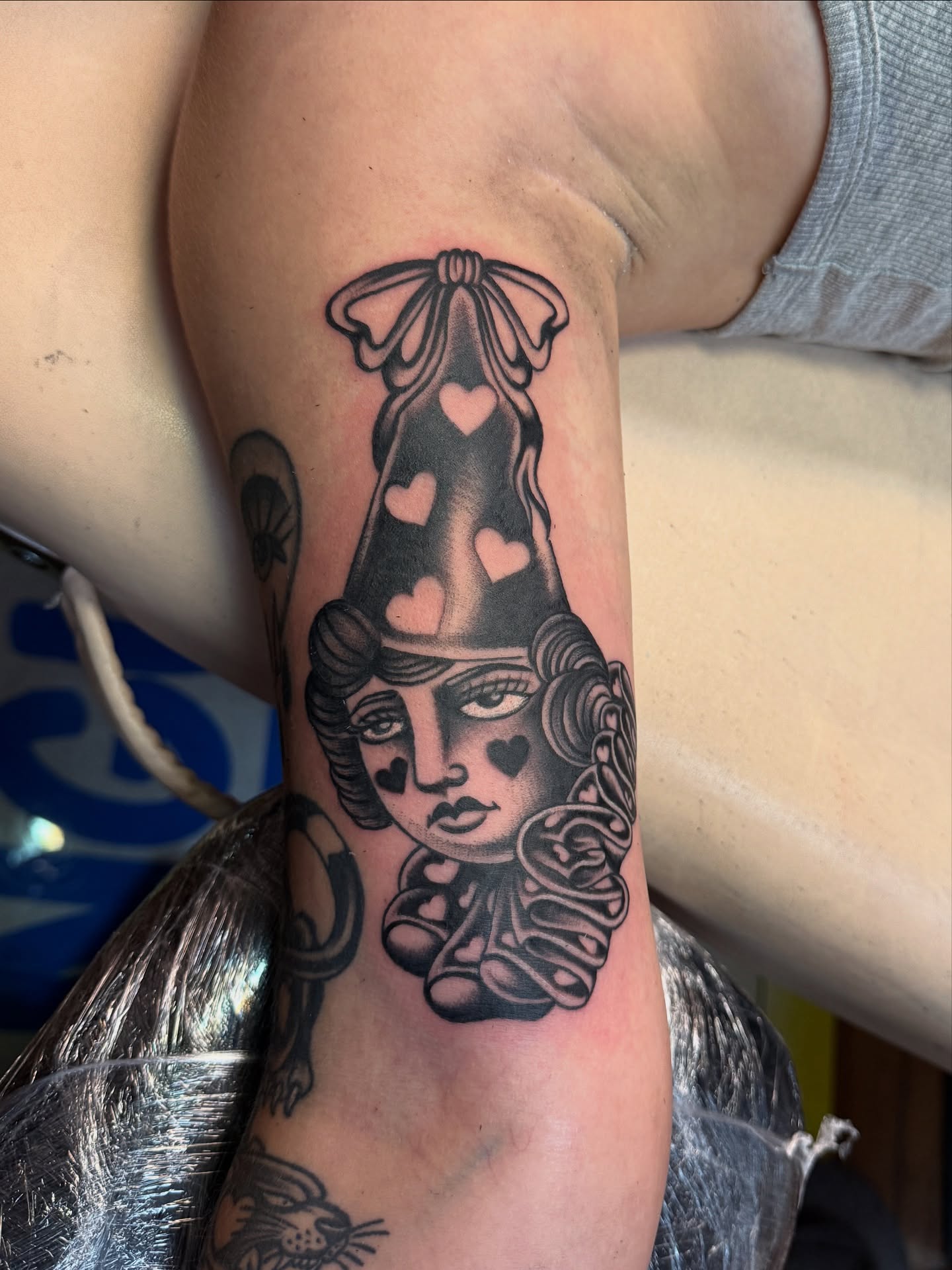 Doll with heart hat American traditional tattoo on the forearm by Angus Perfect, Philadelphia, Pennsylvania