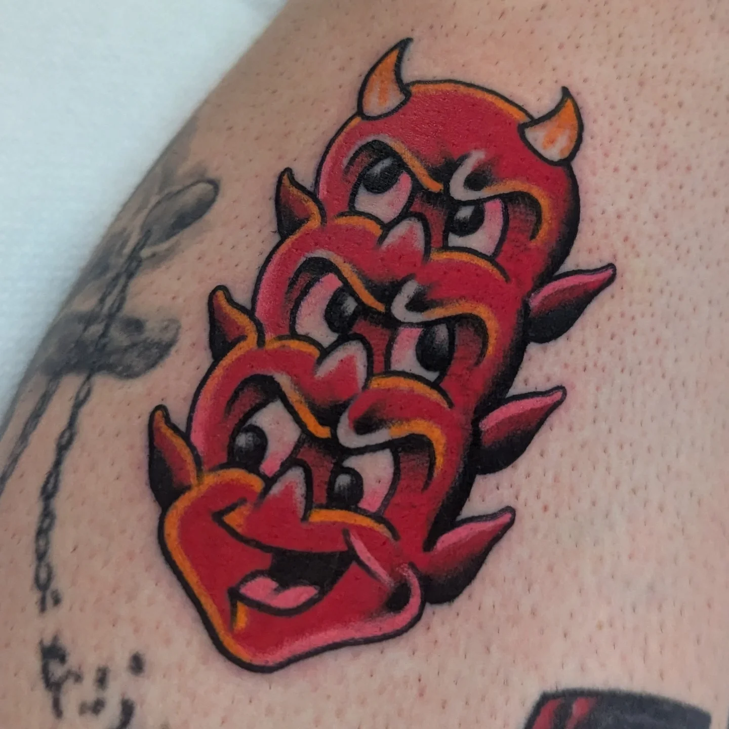 Red devil American traditional tattoo on the forearm by Zack Mueller