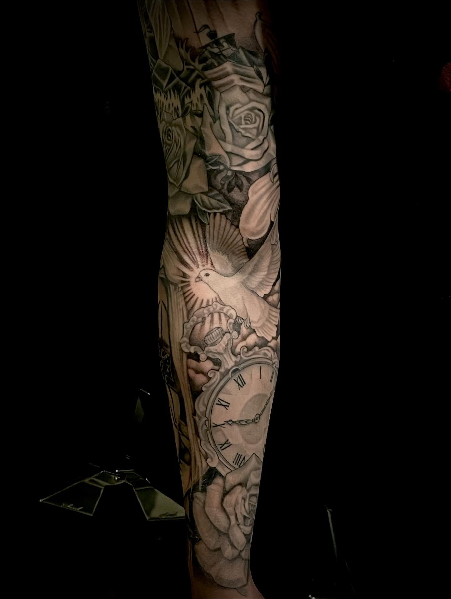 Clock and dove realism tattoo on the forearm by Jacob Finelli