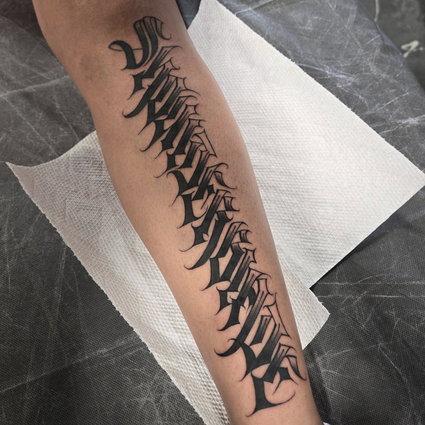 Gothic script black and grey tattoo on the forearm by DiazTattoos, Denver, Colorado