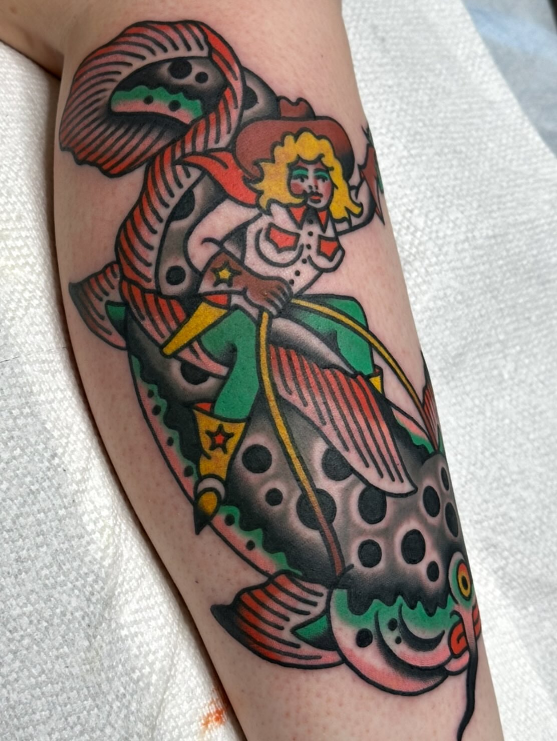 Cowgirl riding fish American traditional tattoo on the forearm by Steve Pearson