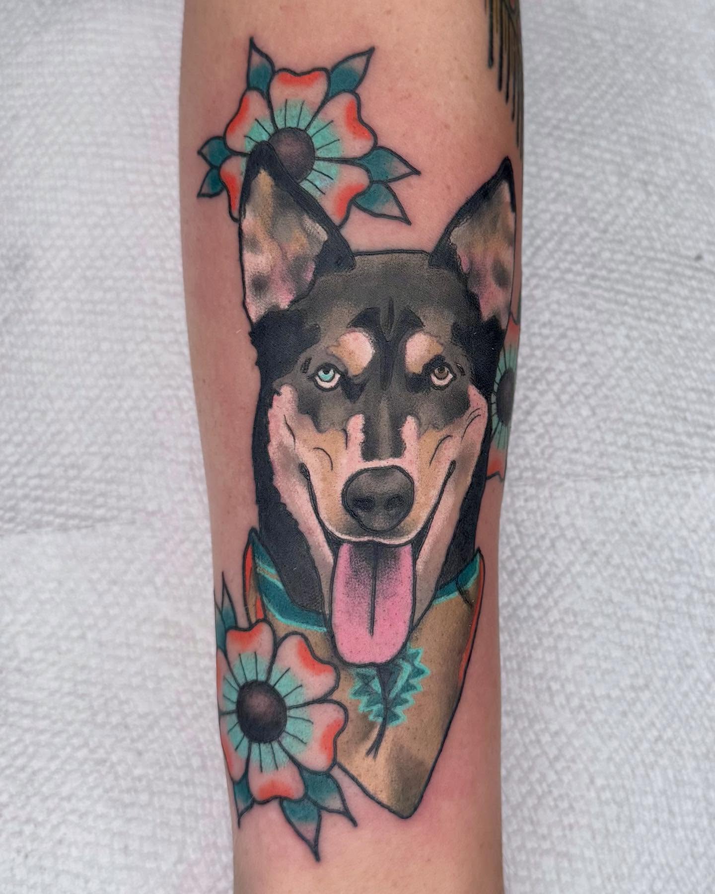 Dog with flowers American traditional tattoo on the forearm by Curtis Stairs, Seattle, Washington