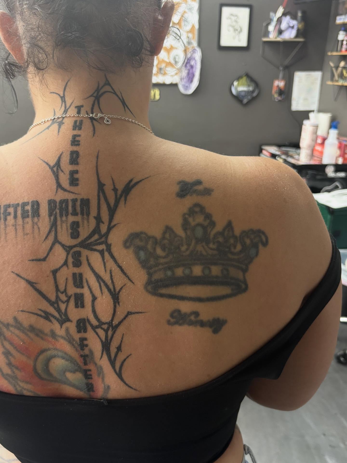 Cross and crown black and grey tattoo on the back by Tattoos by Tessa